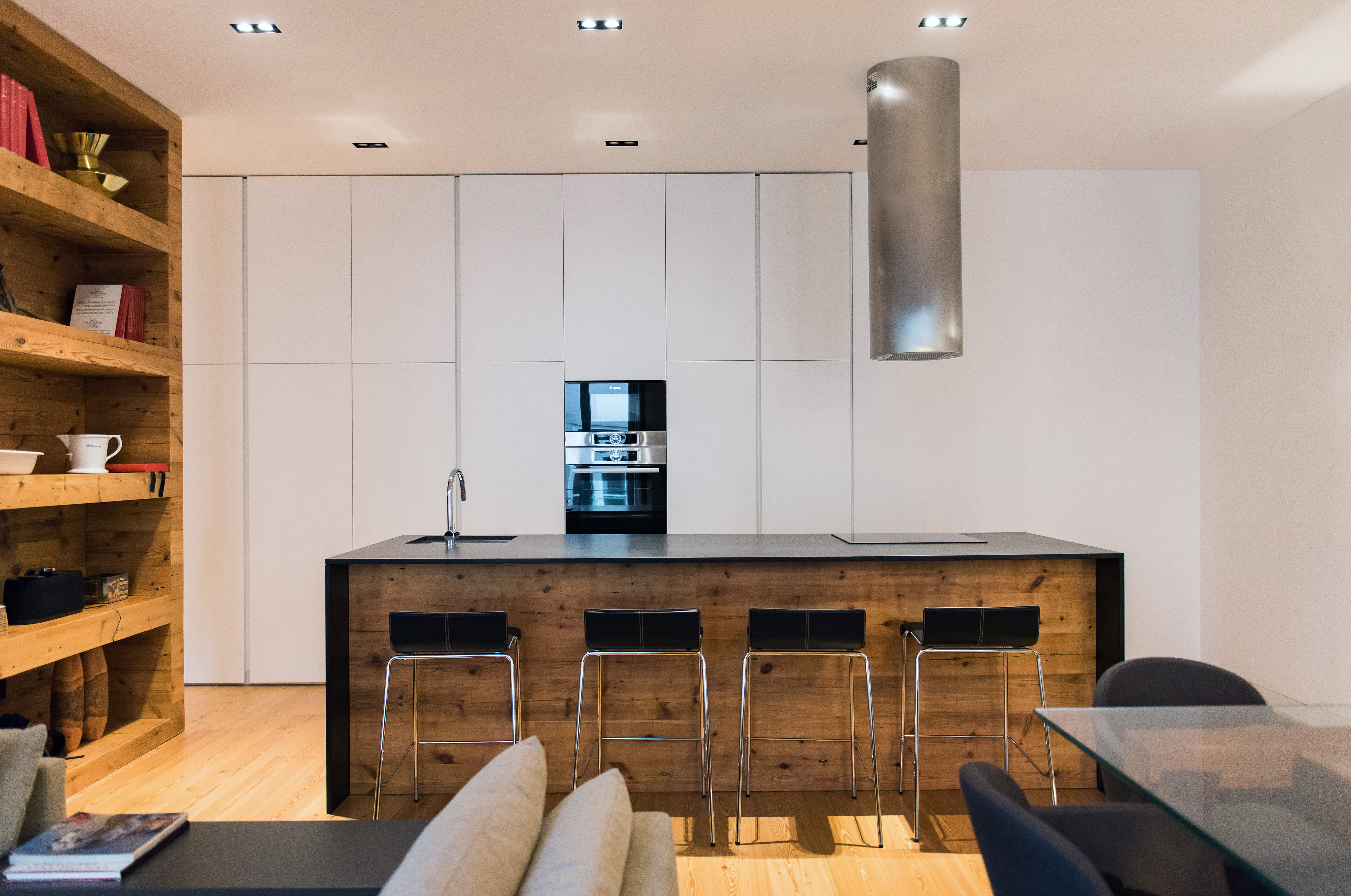 Exclusive Resorts' private villa in Lisbon, Portugal, featuring a modern kitchen with a central island, wooden accents, and sleek cabinetry.