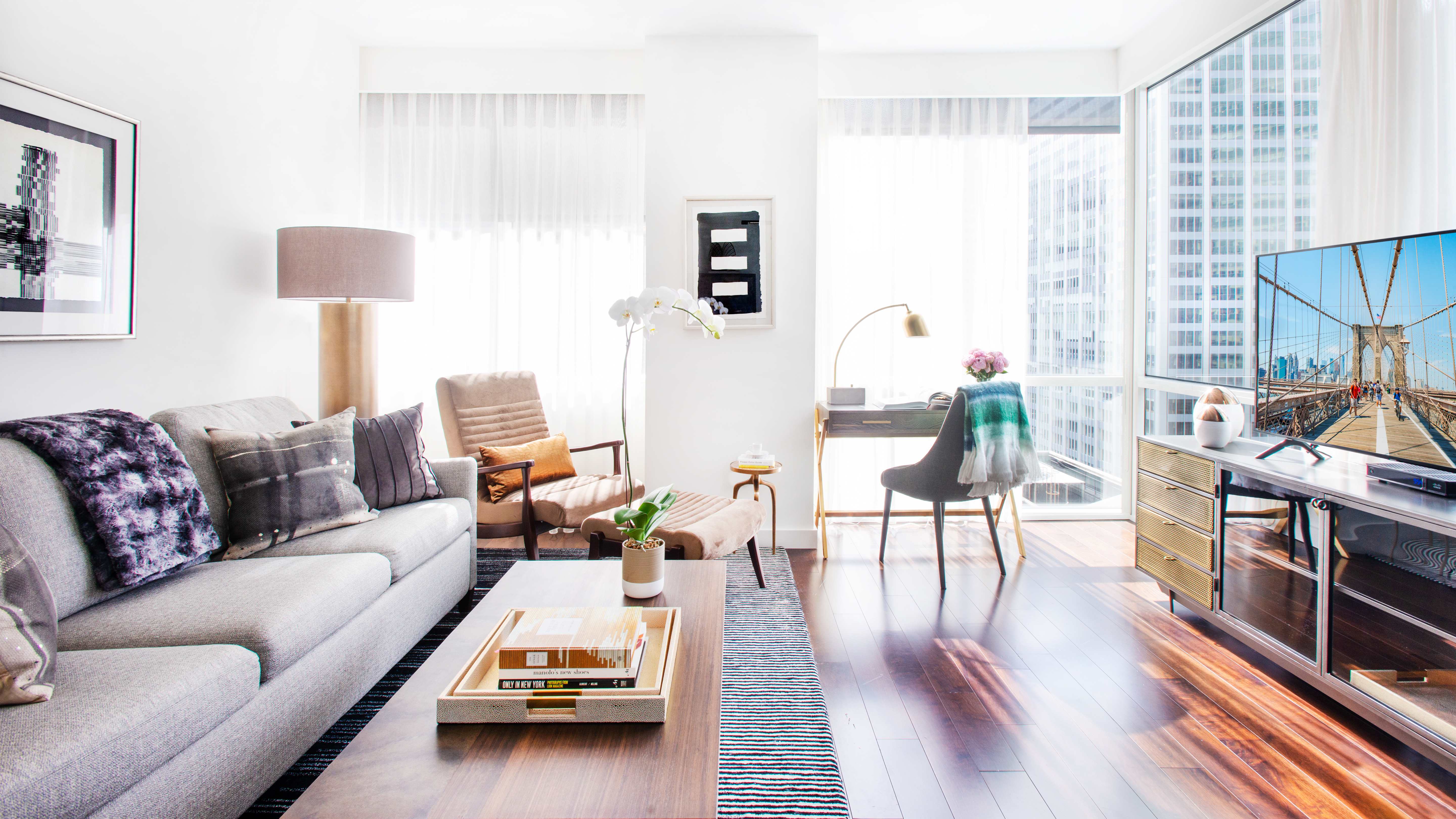Stylish and bright living room with contemporary furnishings in an Exclusive Resorts property at Park Avenue Place in New York City.