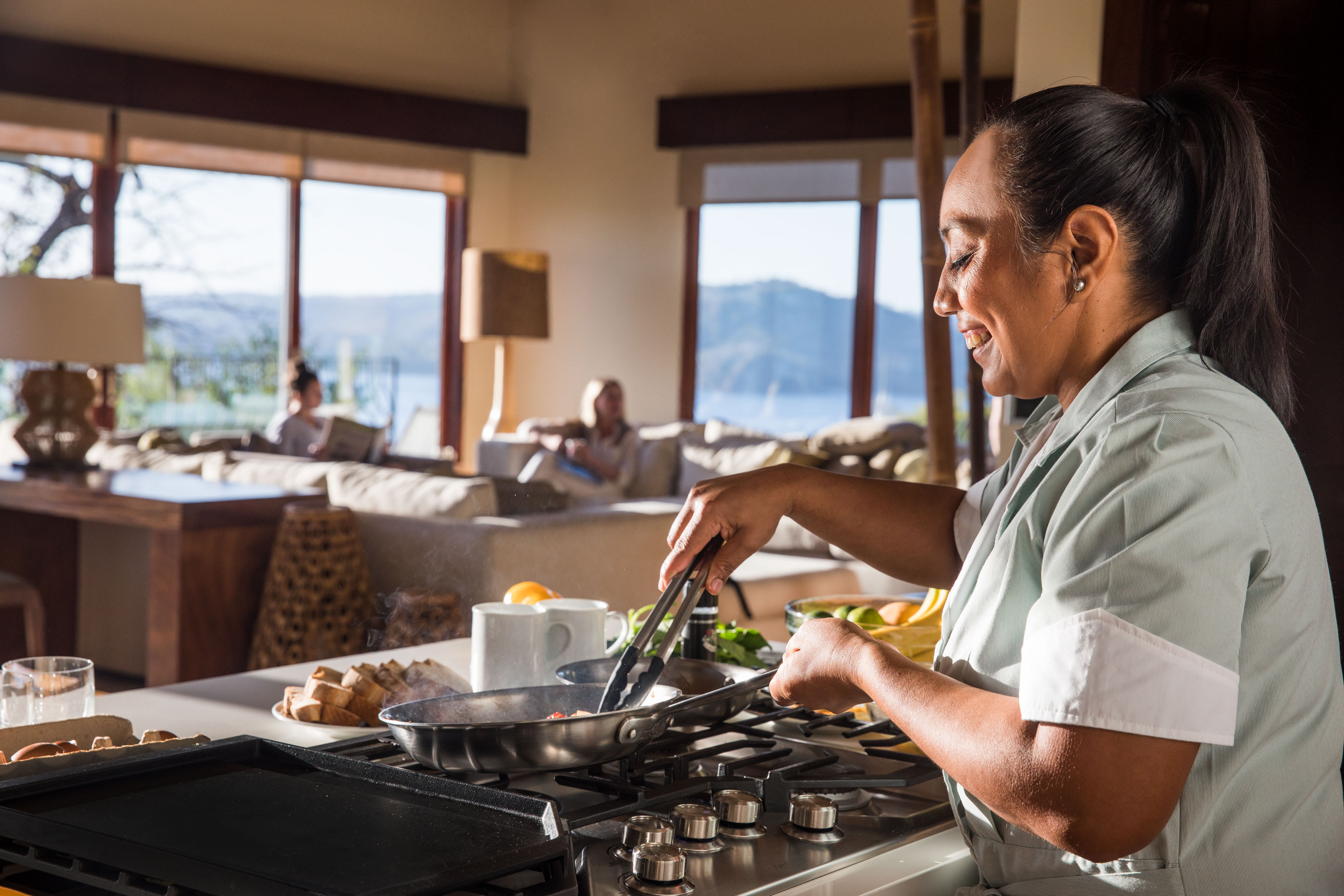 Chef cooking breakfast in a luxurious kitchen with a view in Costa Rica.