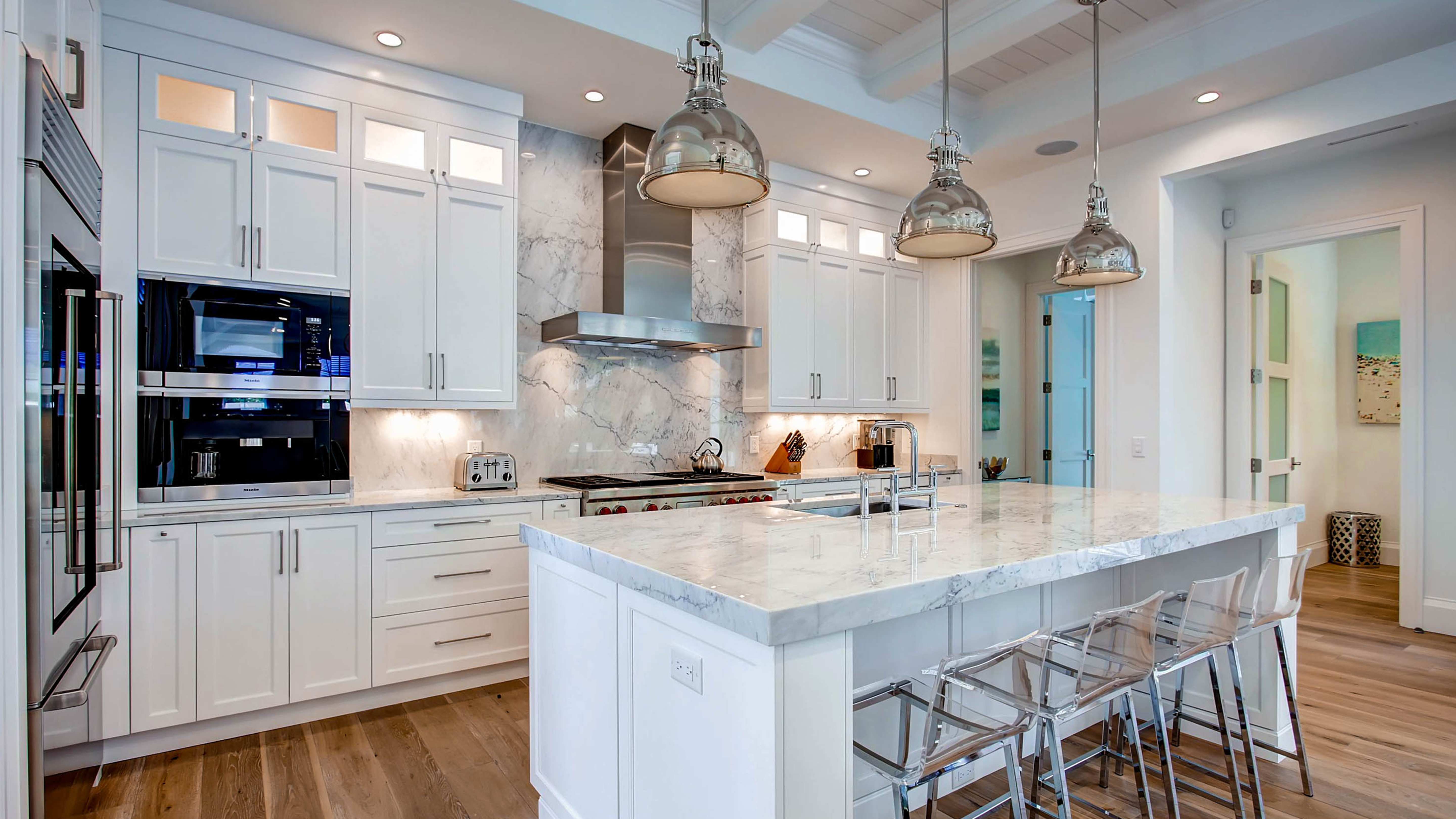 Spacious kitchen with marble countertops and stainless steel appliances in an Exclusive Resorts home in Naples, Florida.