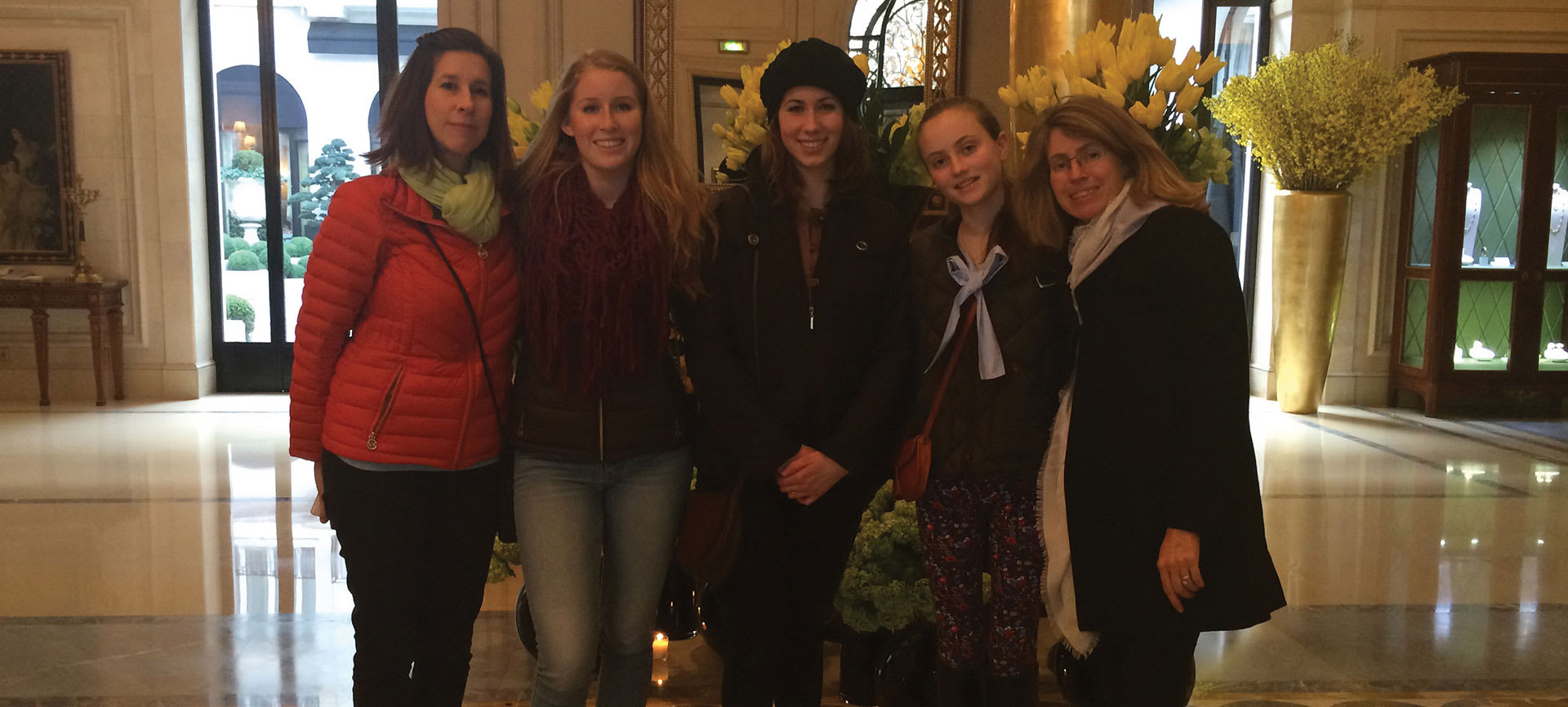 Family posing for a picture in a hotel lobby.