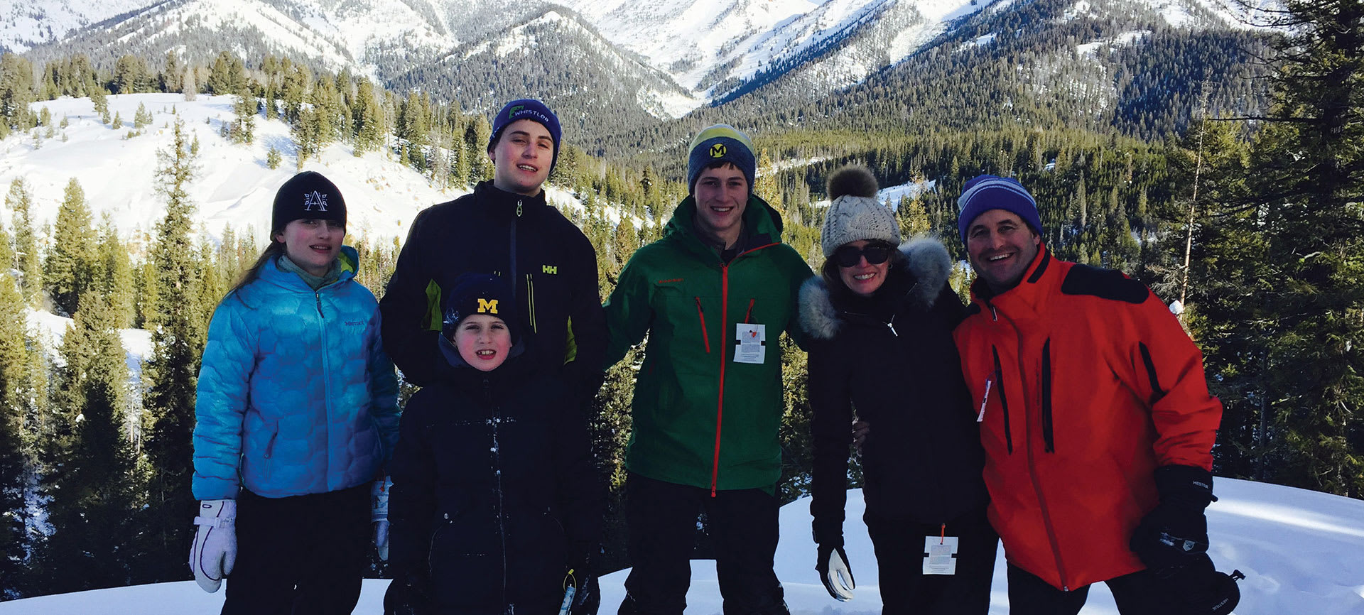 Family posing for a picture in the mountains.