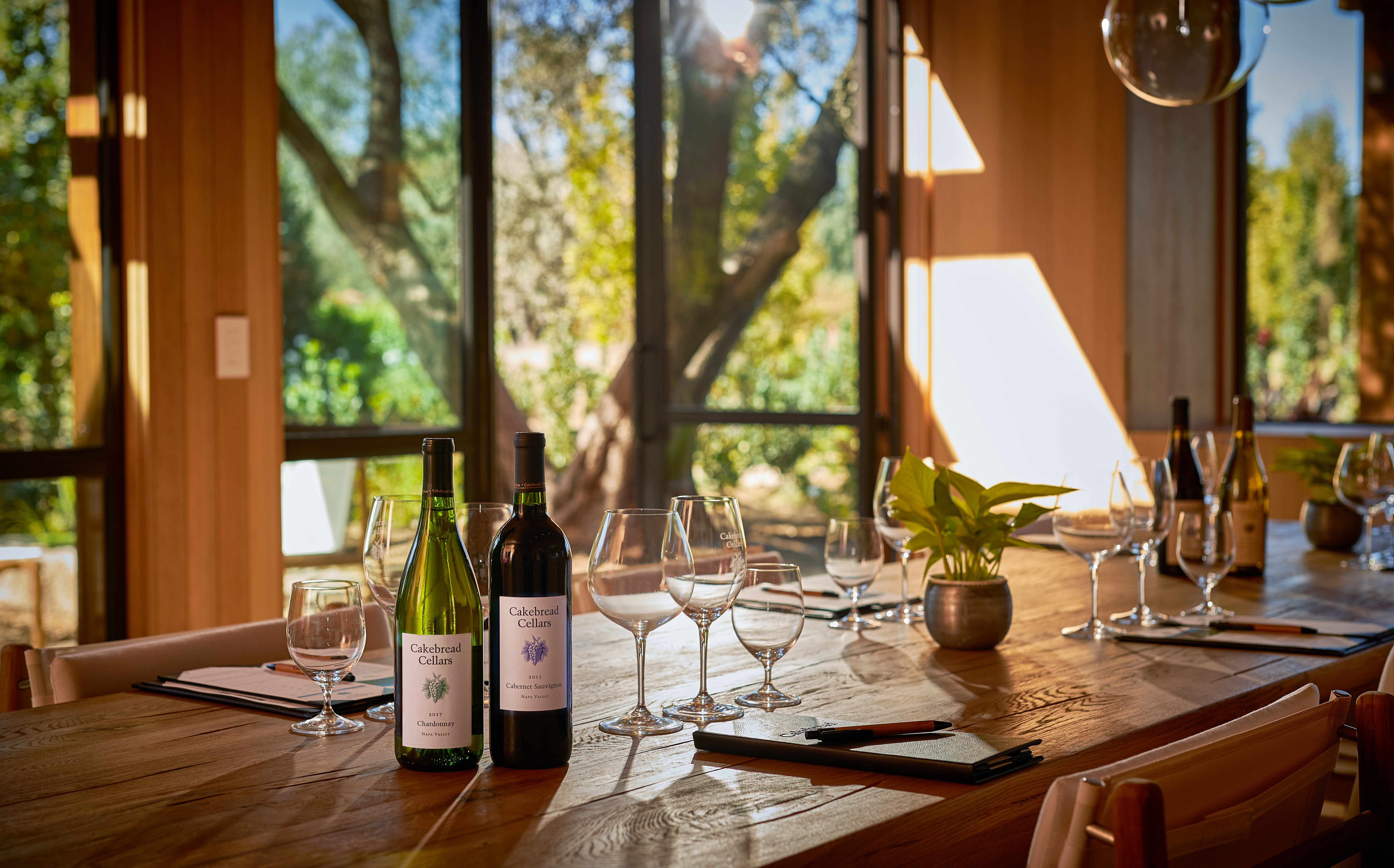Indoor dining table set with wine bottles at Cakebread Cellars in Napa Valley.