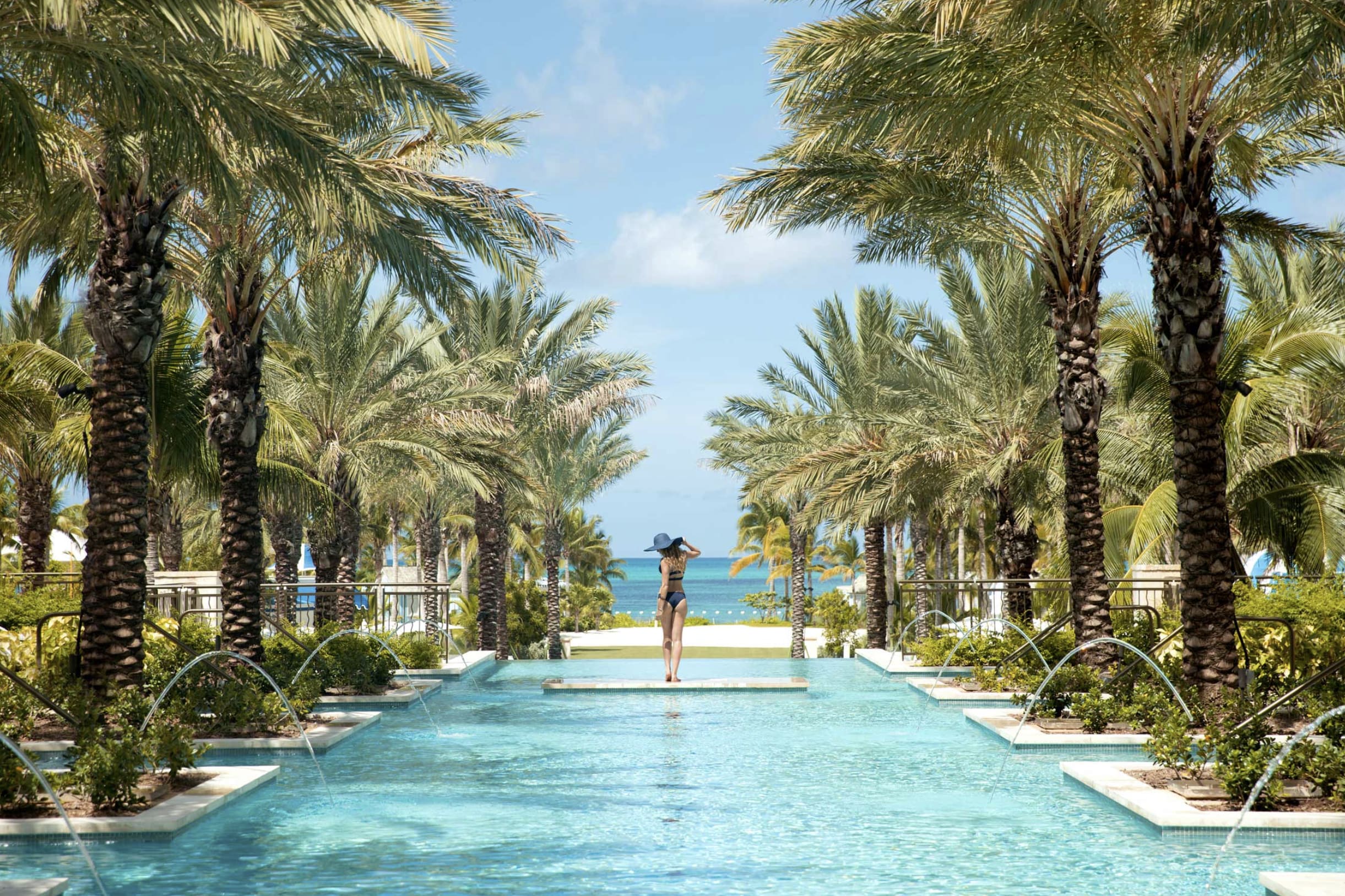 A woman posing in the middle of a resort pool in Baha Mar, Bahamas.