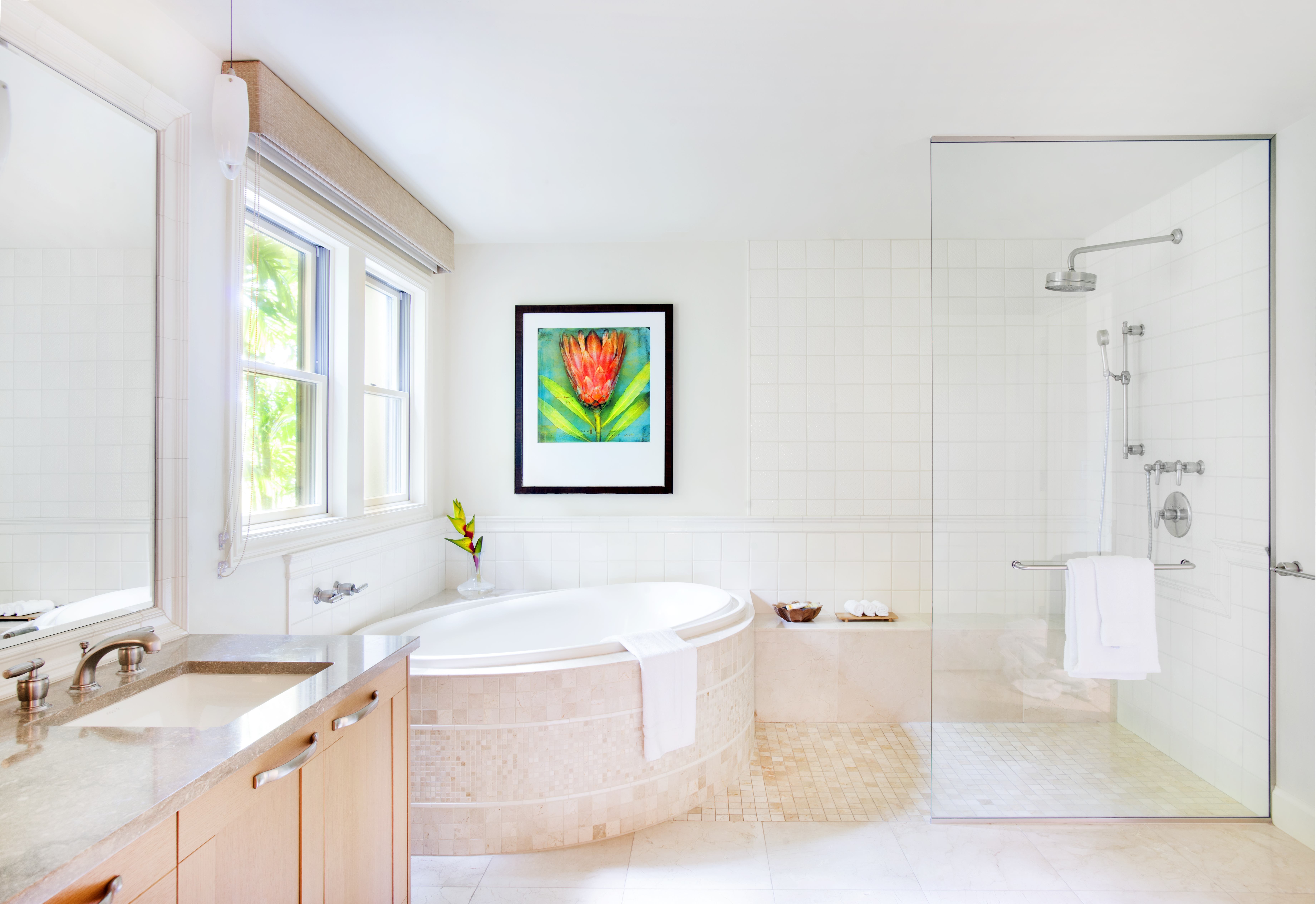 Bright bathroom with a spa-like bathtub and glass shower in an Exclusive Resorts property in Wailea.