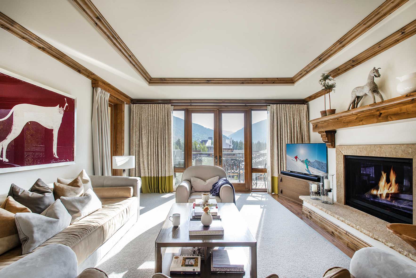 Exclusive Resorts property living room at The Arrabelle at Vail Square with mountain views and cozy fireplace.