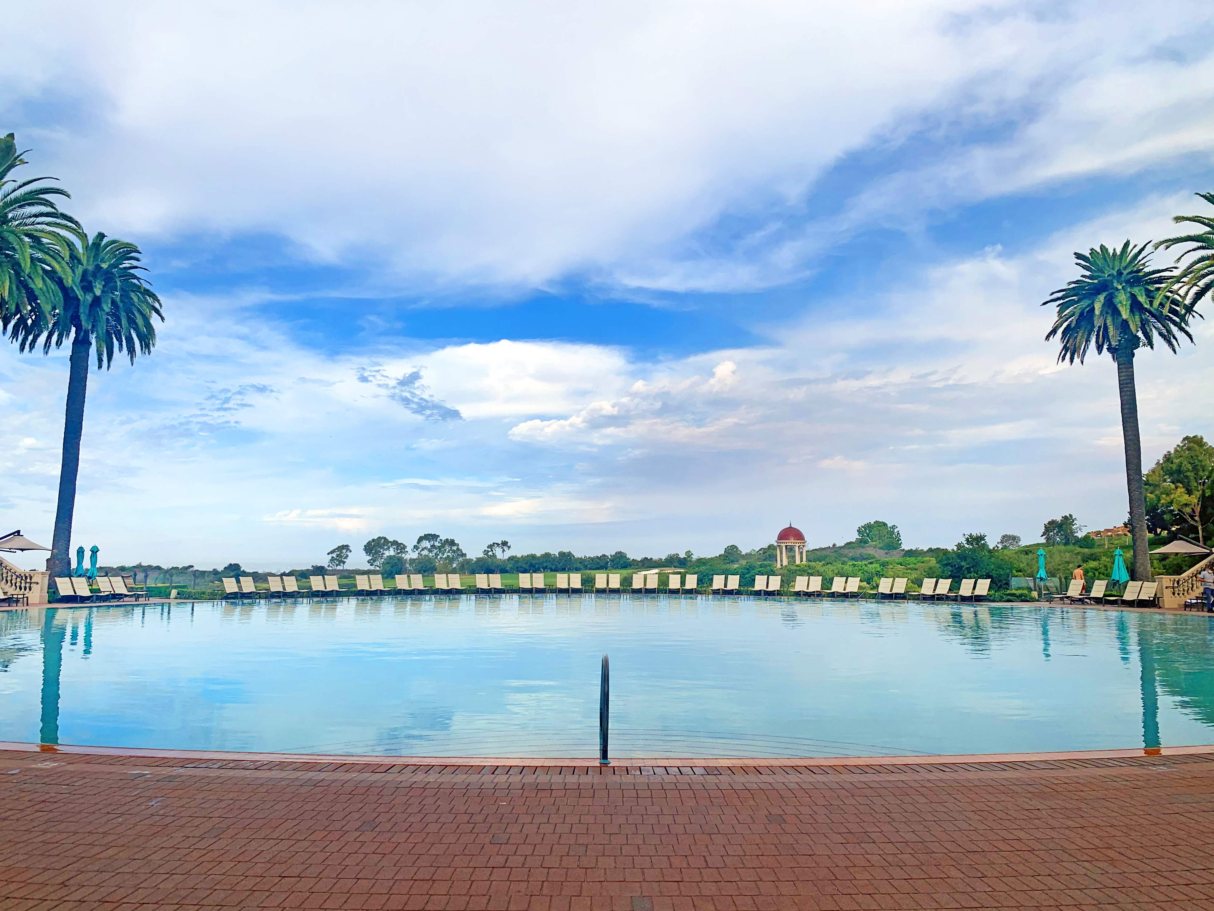 Coliseum Pool with a sweeping ocean view at Pelican Hill in Newport, close to Exclusive Resorts properties.