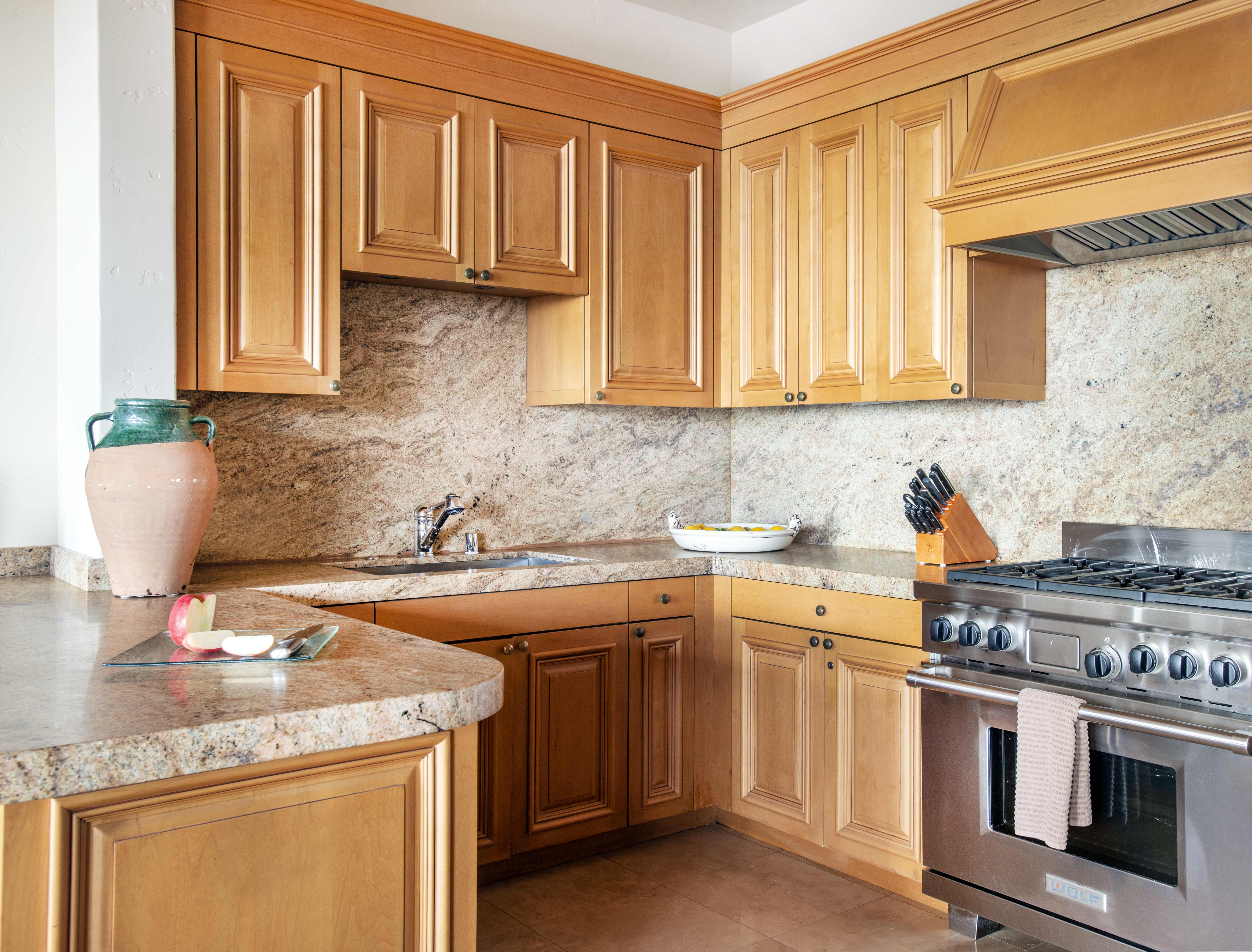 Fully-equipped kitchen with wooden cabinetry and granite countertops in an Exclusive Resorts property at Pelican Hill.