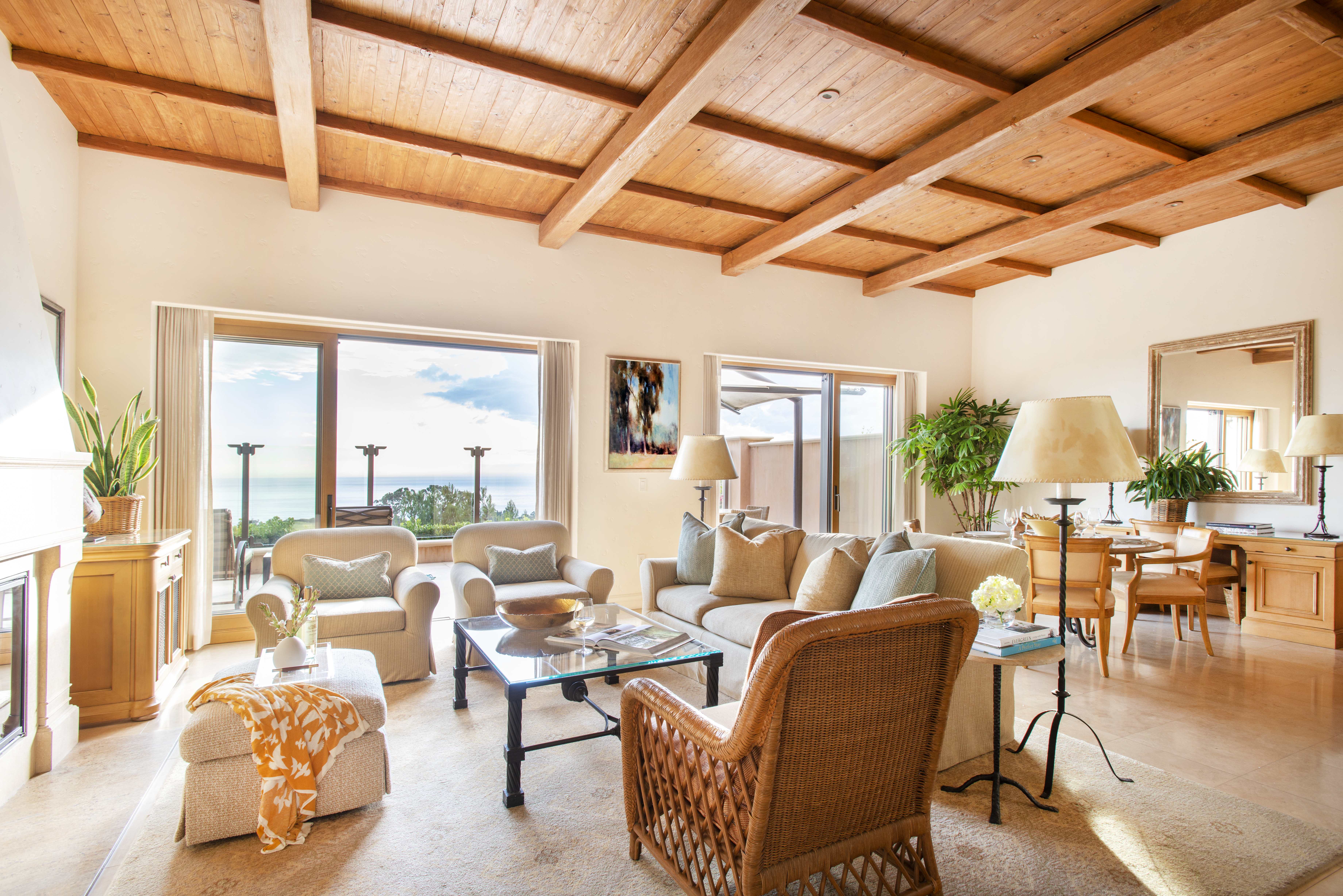 Spacious living area with high ceilings with an ocean view at an Exclusive Resorts property at the Pelican Hill Resort.