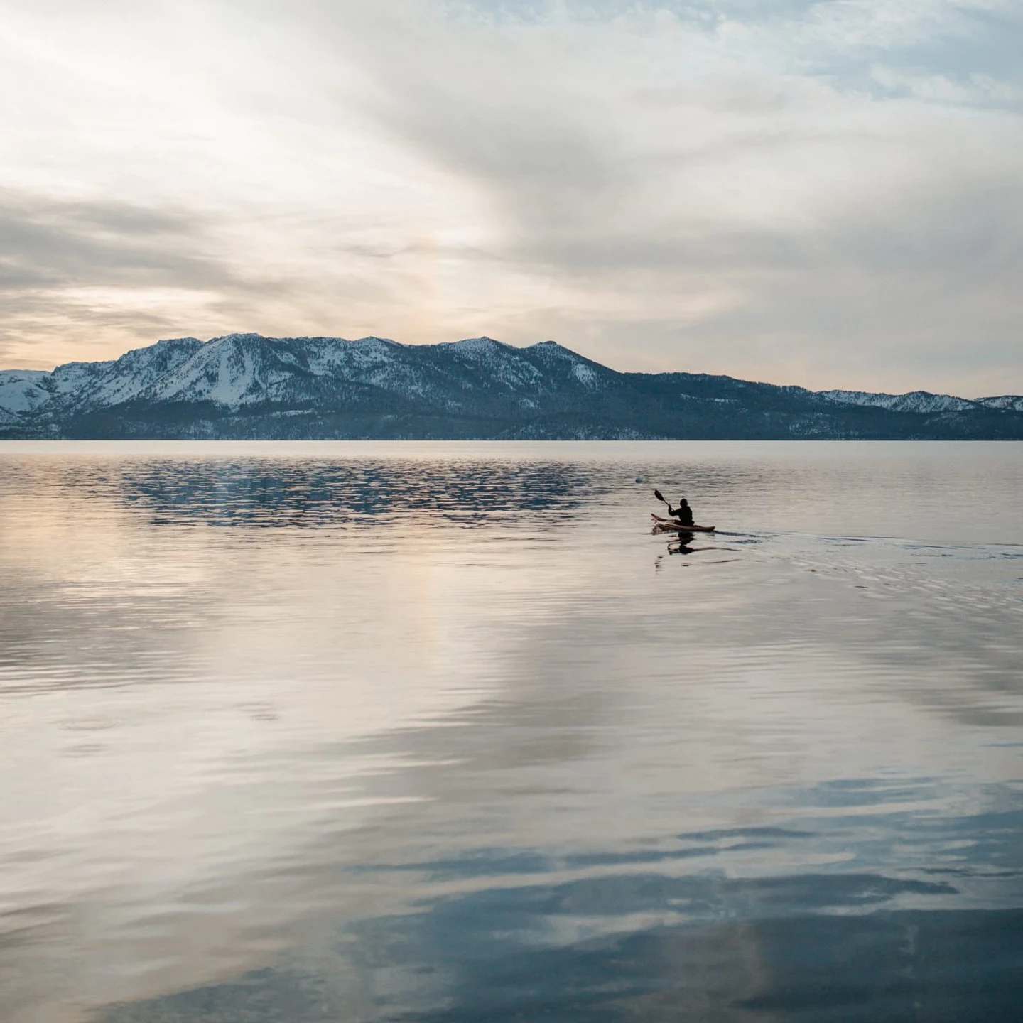 A man kayaking in Lake Tahoe, California.
