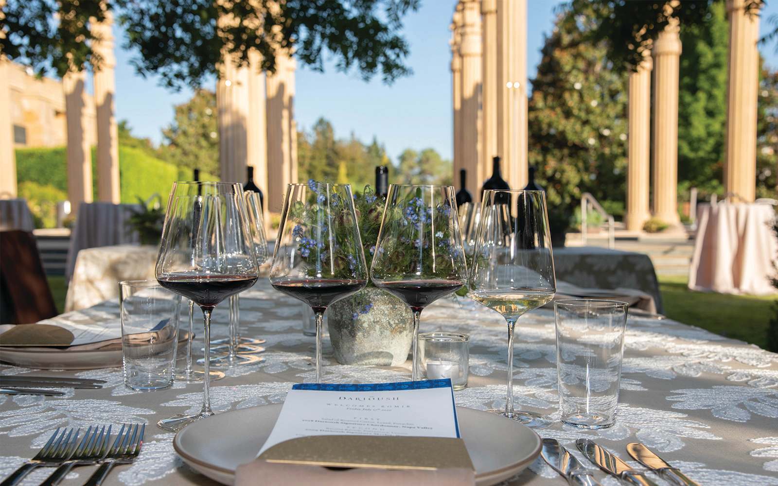 Outdoor dining setup at Darioush Estate winery in Napa Valley with elegant table settings and vineyard views