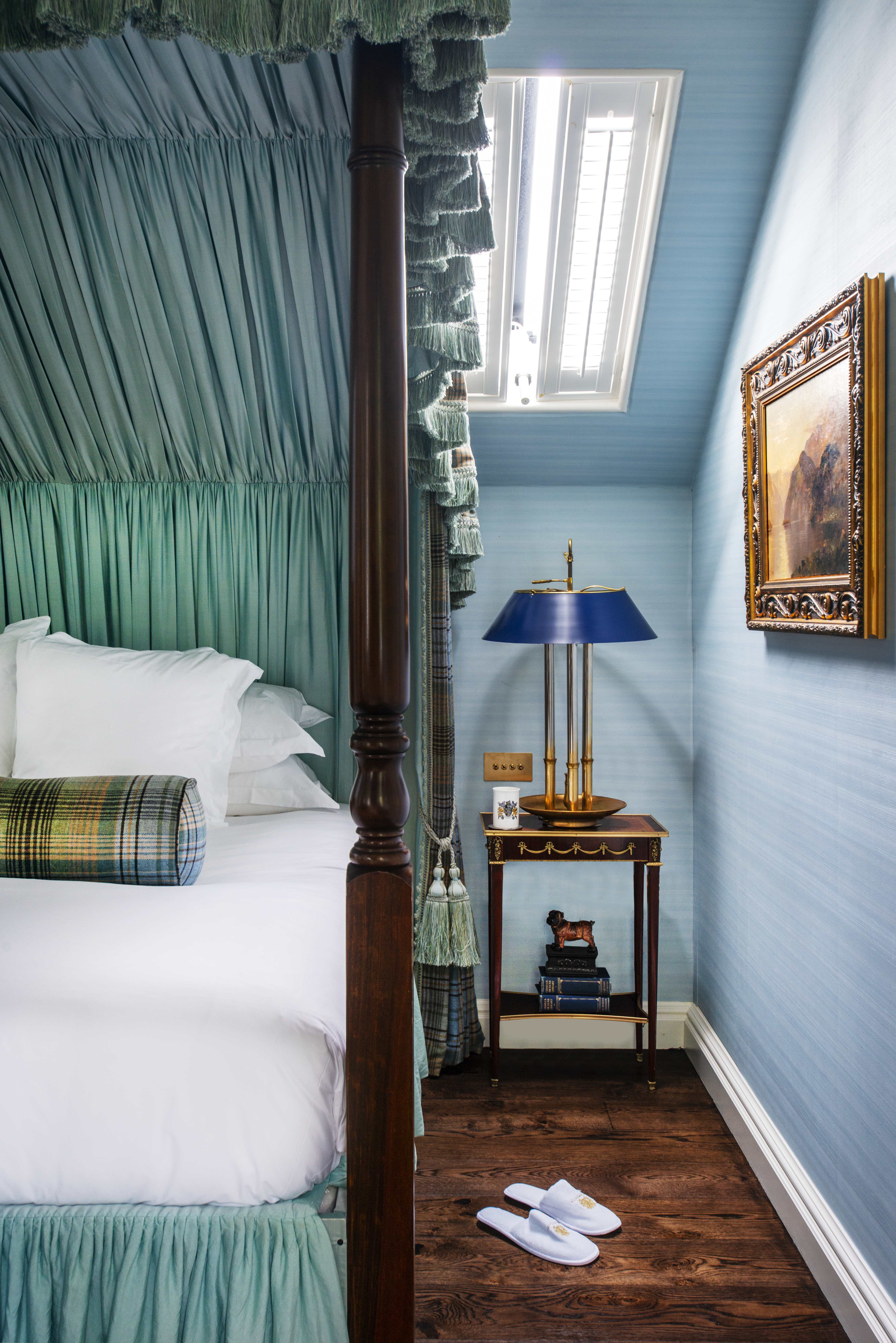A private bedroom with slippers aside from the bed.
