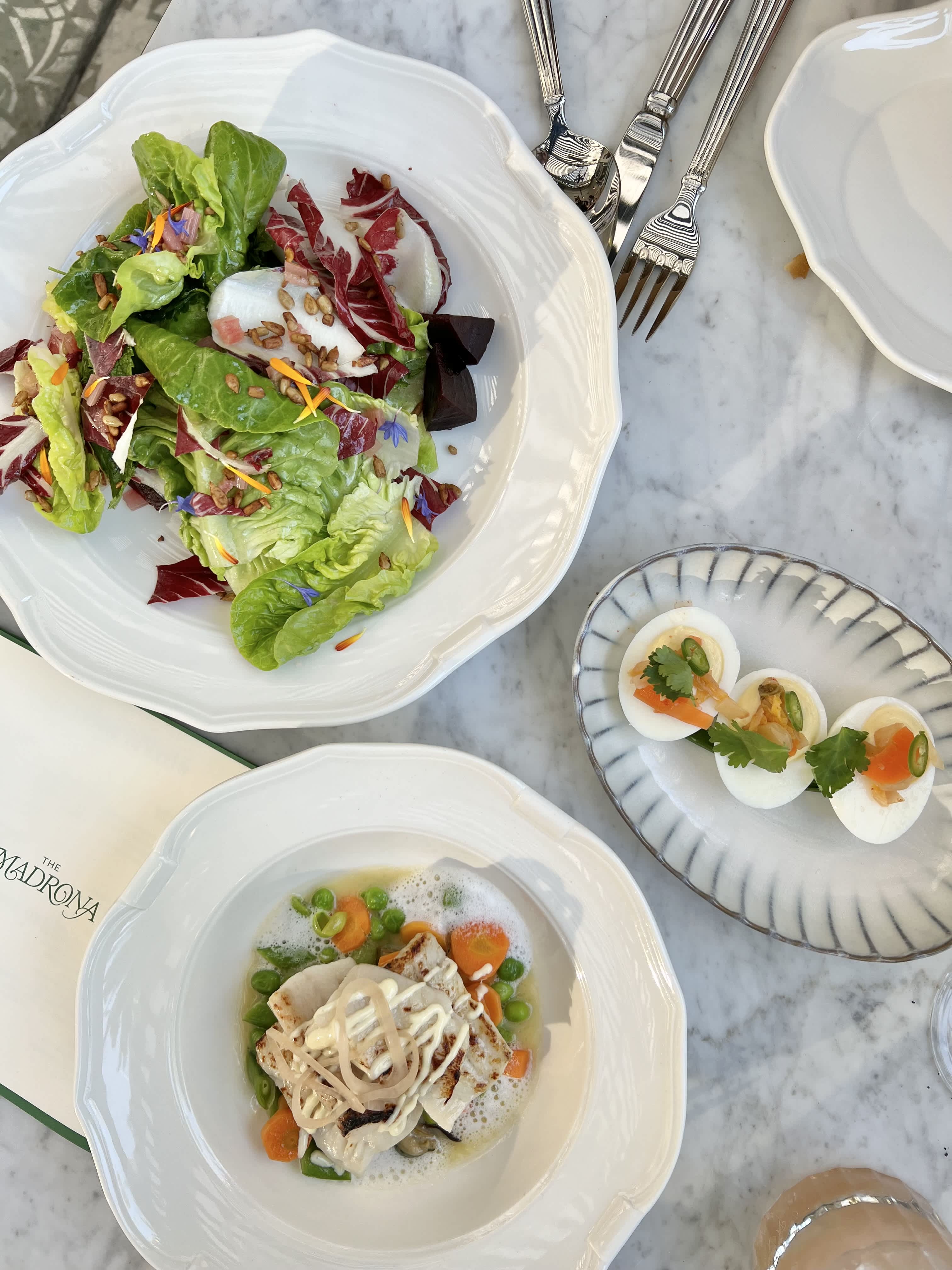 Three plates of food on a table.