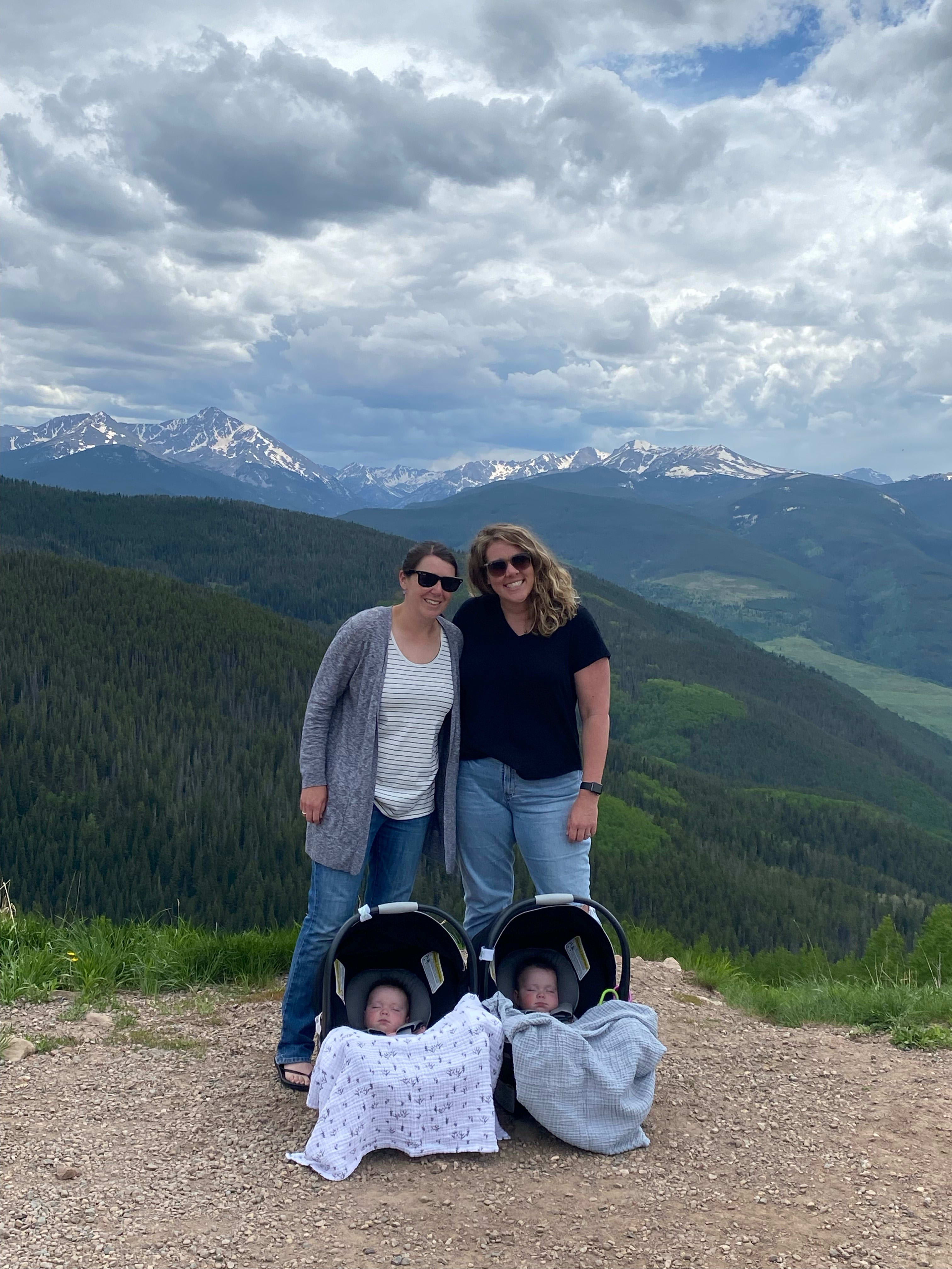 Two women with mountains in the background.