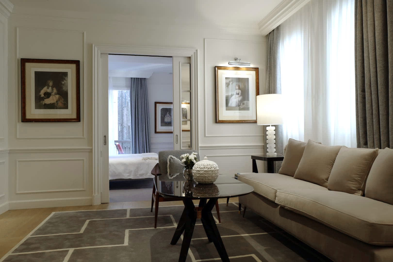 Exclusive Resorts' luxury apartment in Florence, Italy, featuring an elegantly decorated living room with a view into the bedroom.