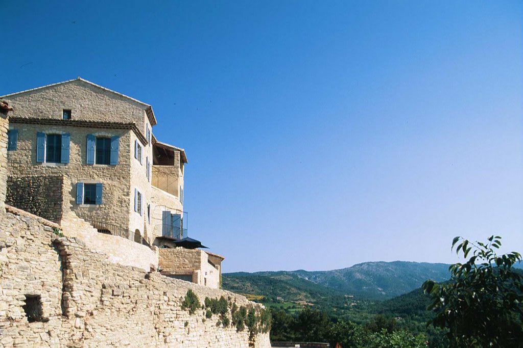 Exclusive Resorts' private villa in Provence, France, with rustic stone architecture and scenic mountain views.