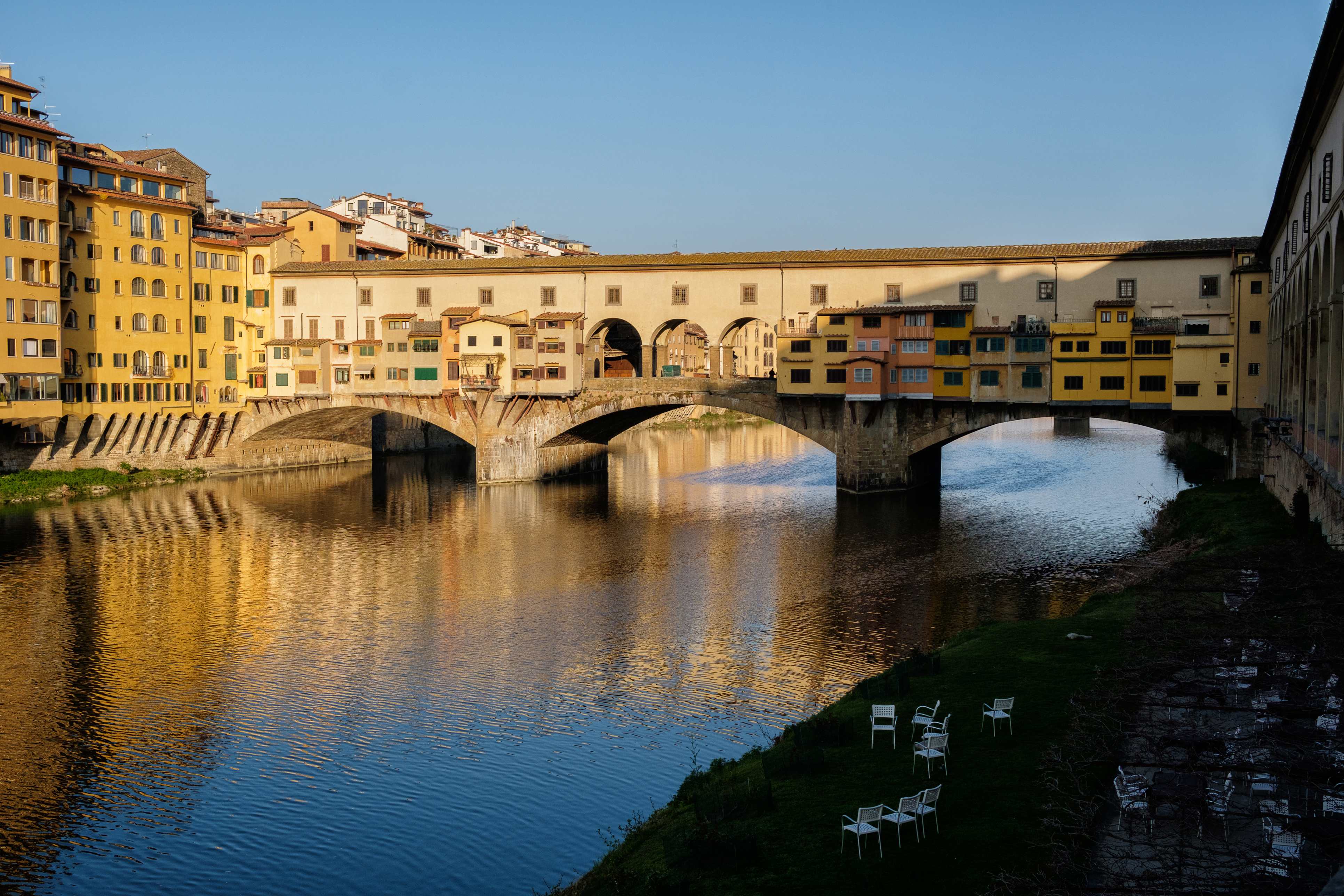 Ponte Vecchio bridge over the Arno River at sunset in Florence, Italy