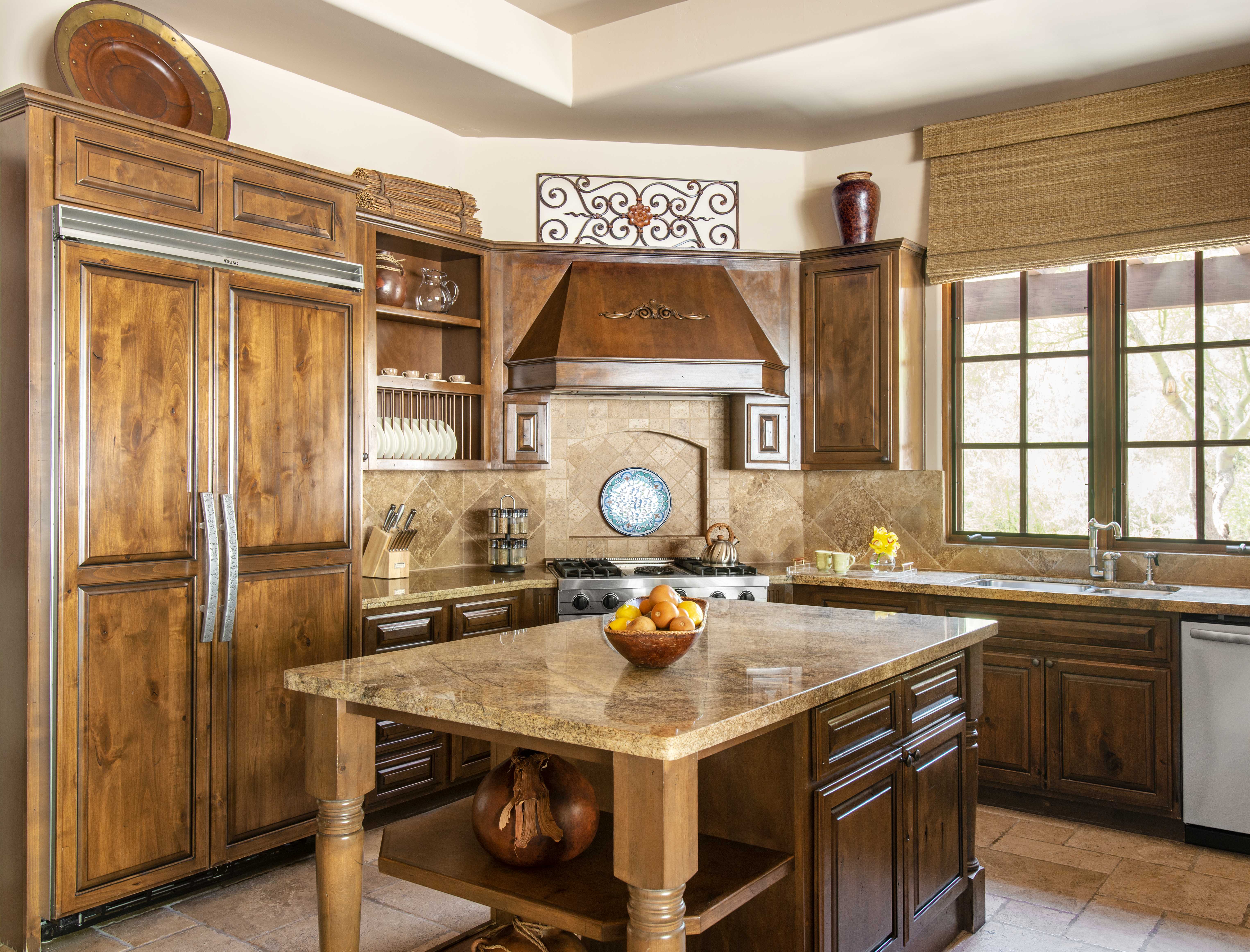 Kitchen with rich wooden cabinetry and granite countertops in an Exclusive Resorts property at The Rocks Club, Scottsdale.