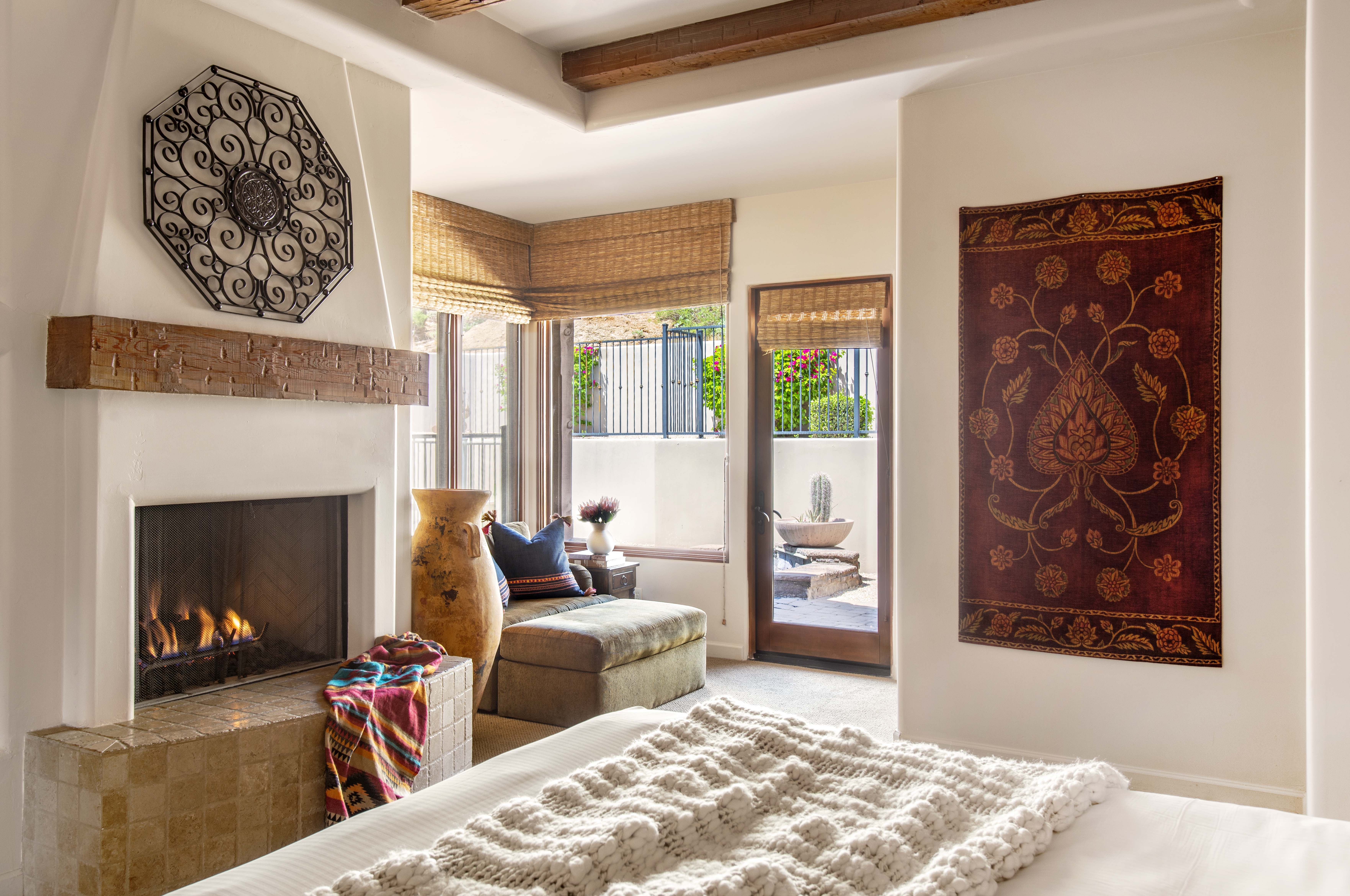 Bedroom with fireplace and decor at an Exclusive Resorts property at The Rocks Club in Scottsdale.