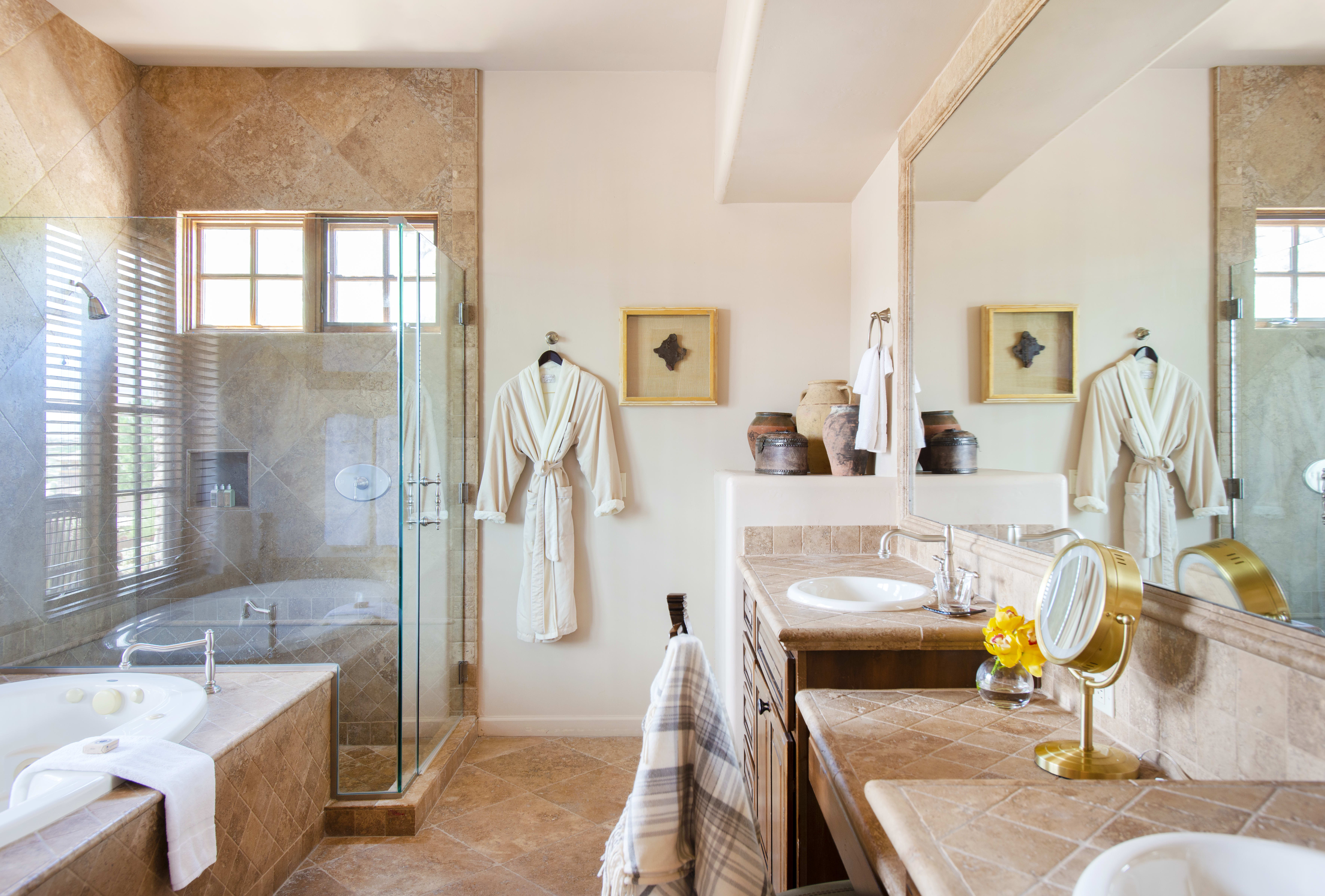 Ensuite bathroom with bath tub and walk-in shower at an Exclusive Resorts property at The Rocks Club in Scottsdale.