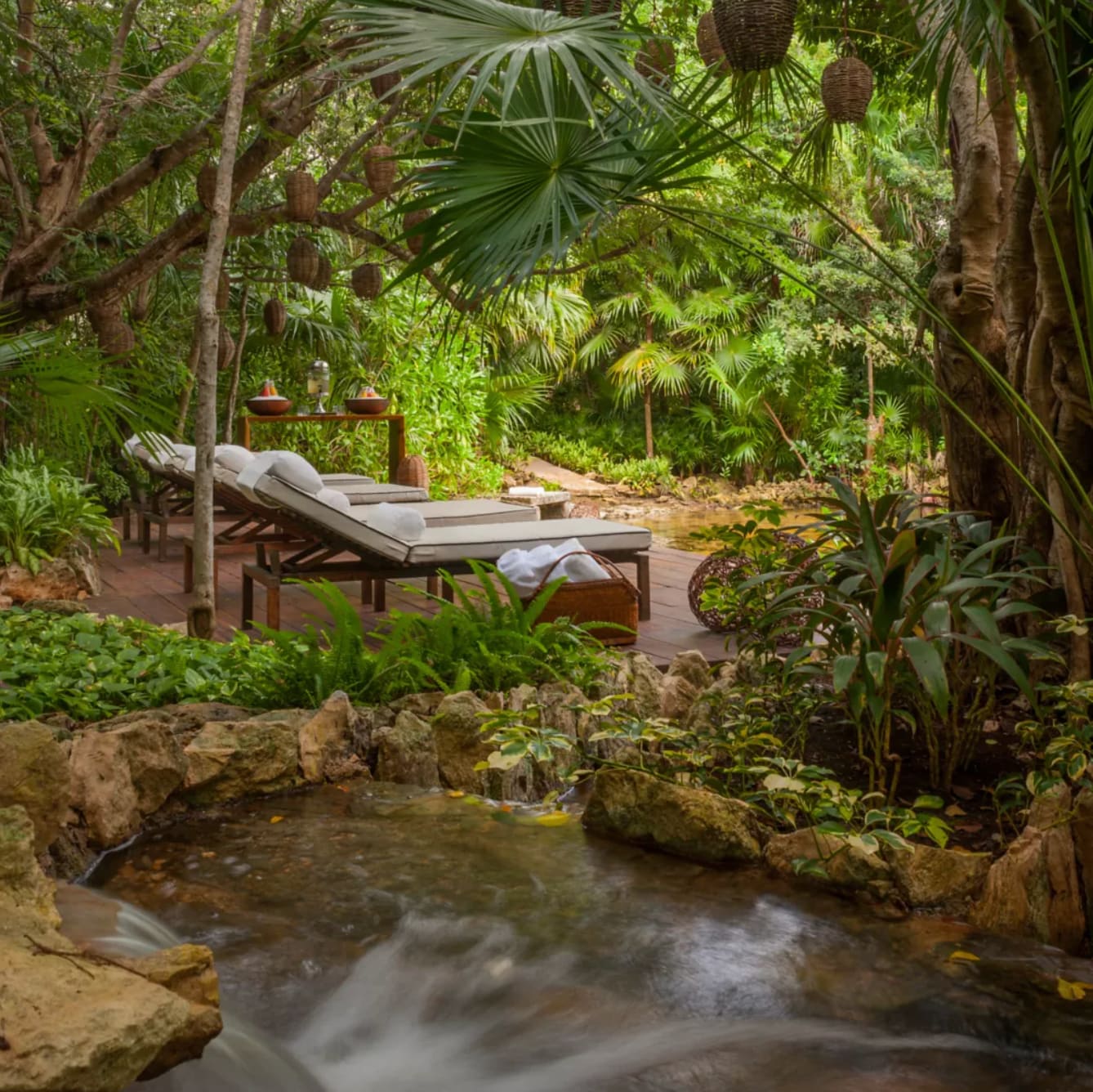 Secluded spa treatment area nestled within the tropical gardens of the Rosewood Mayakoba Spa, offering a serene retreat.