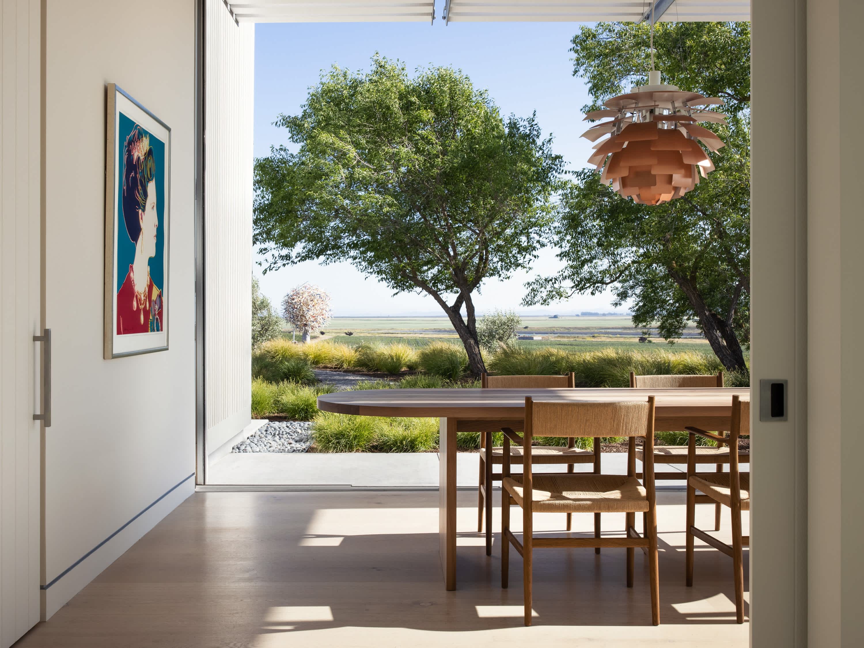 Interior view of a room at Donum Estate in Napa Valley overlooking a garden and vineyard