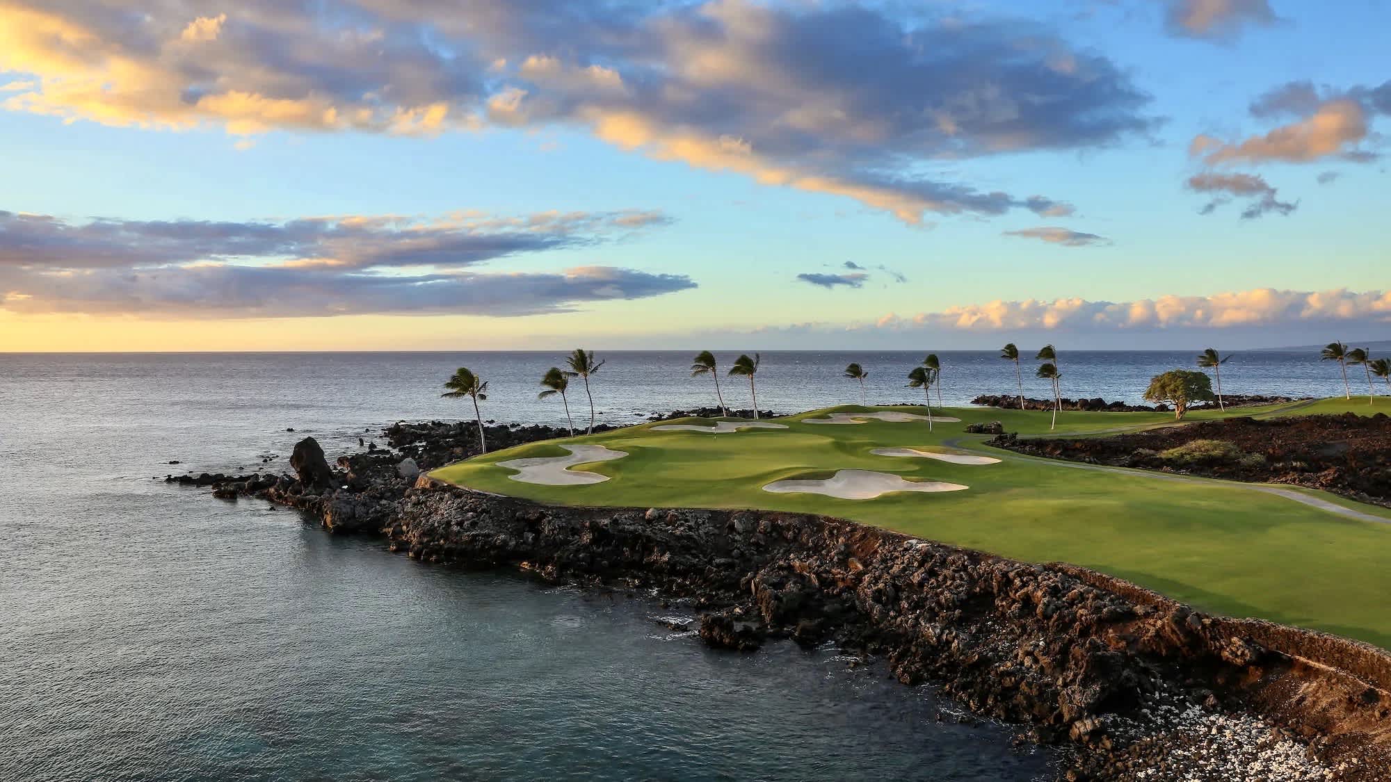 Coastal golf course with ocean views at sunset on the Kohala Coast.