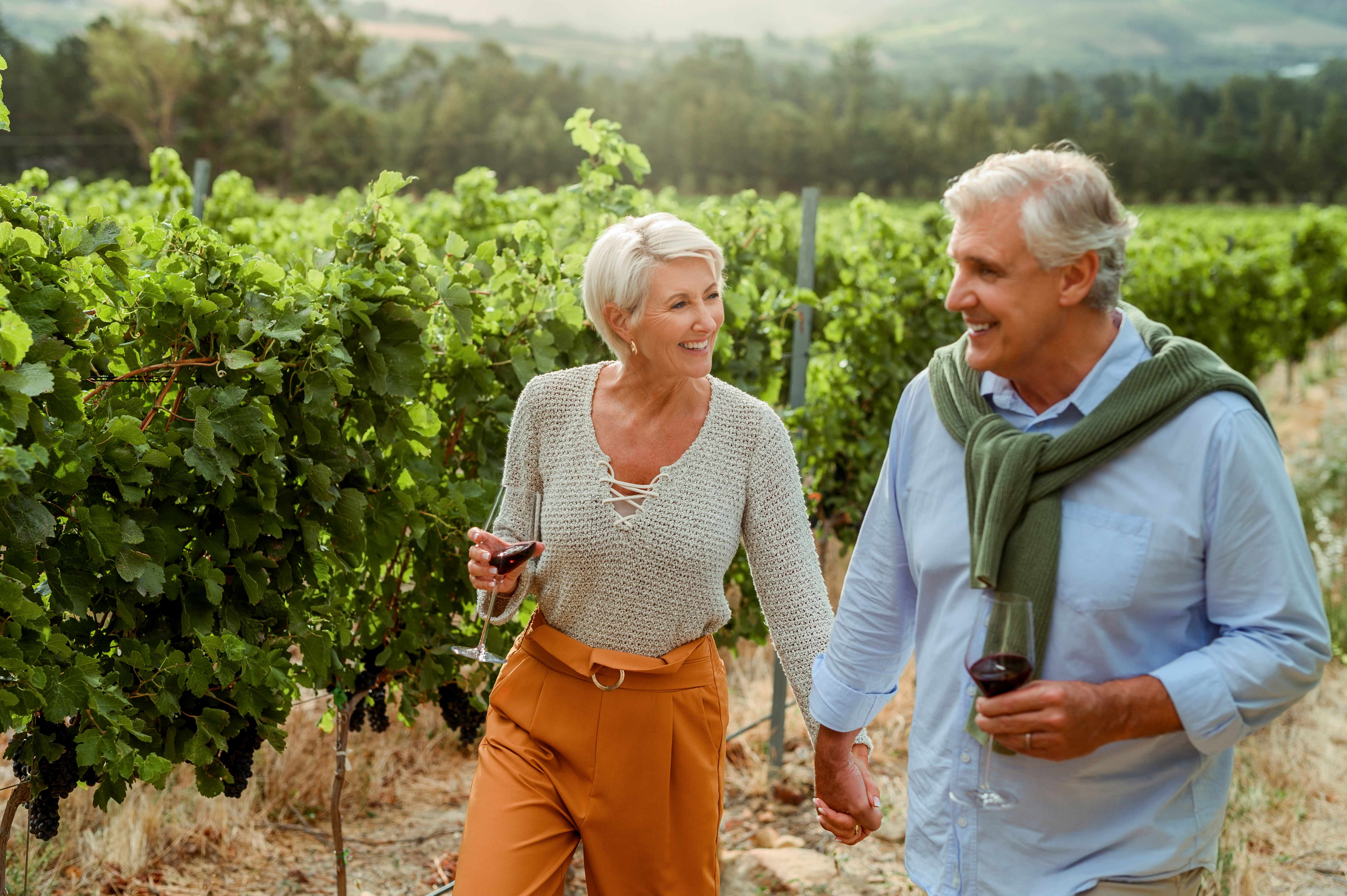 Senior couple enjoying a walk in a vineyard in Napa Valley