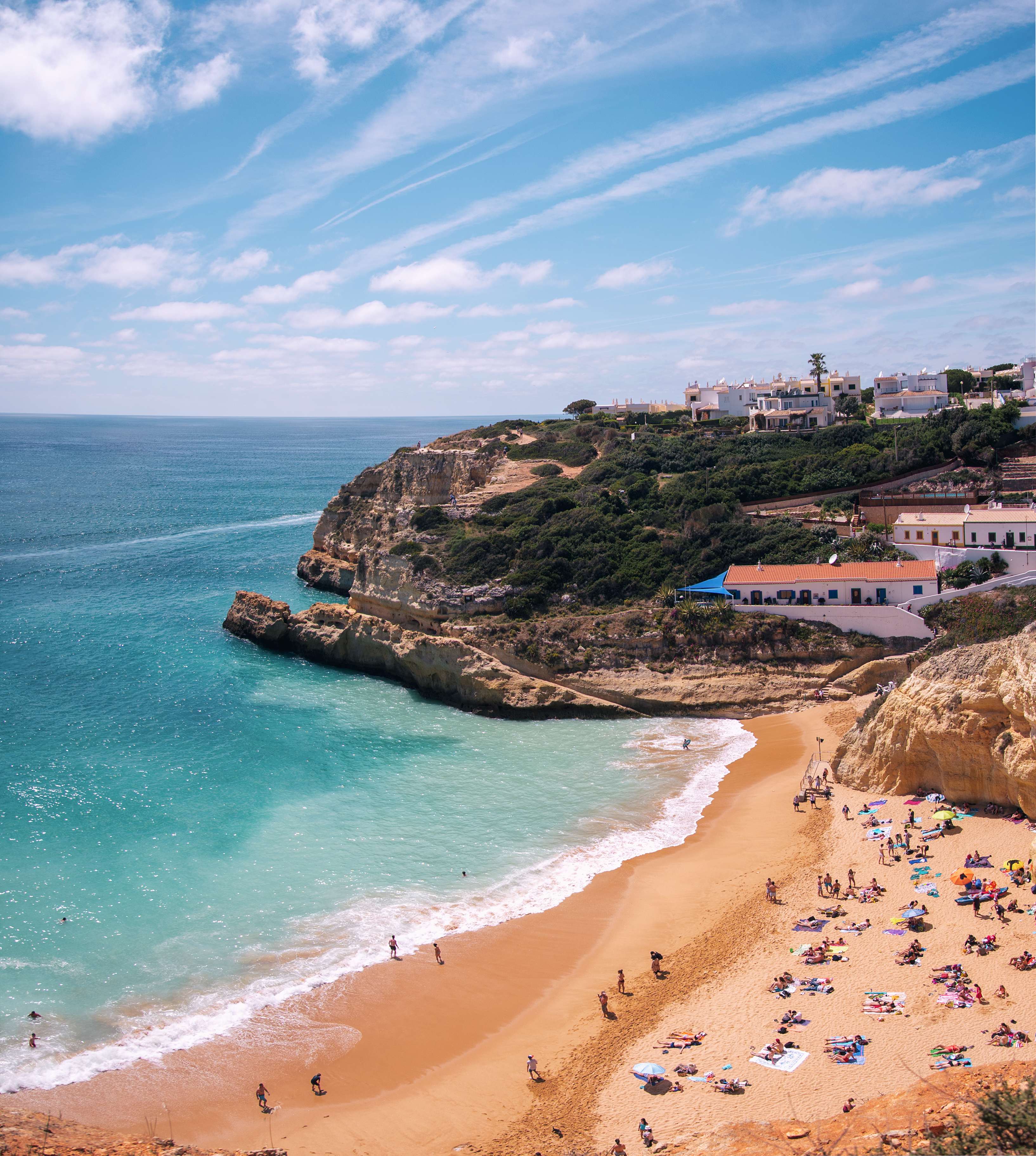 Aerial view of Praia da Dona Ana with turquoise waters, sandy beach, and cliffs in Algarve, Portugal.