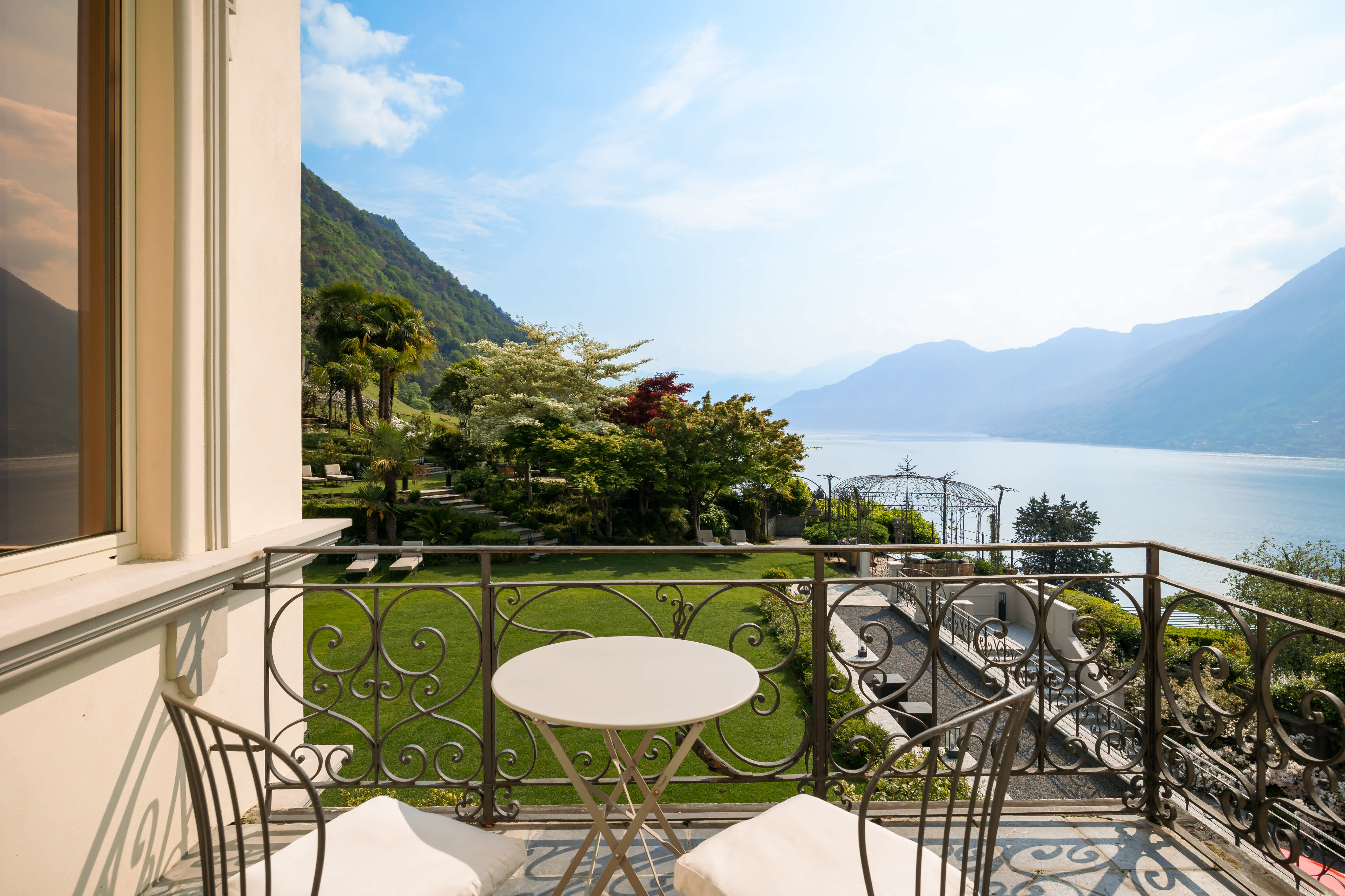 Exclusive Resorts' private villa balcony with a view of Lake Como and surrounding mountains, Italy.