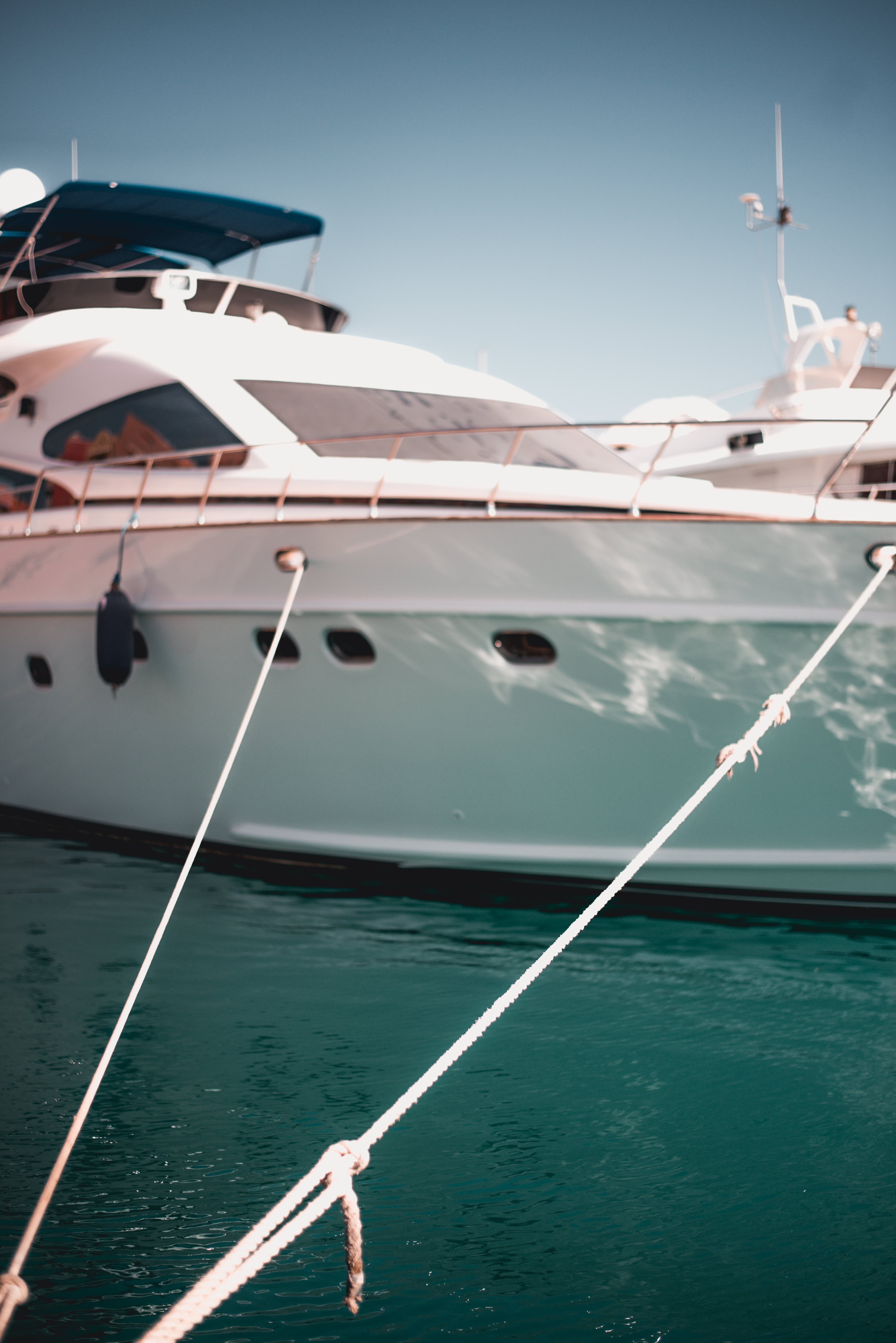 Close-up of a luxury yacht docked in the harbor, with ropes securing it to the pier in the Maldives.