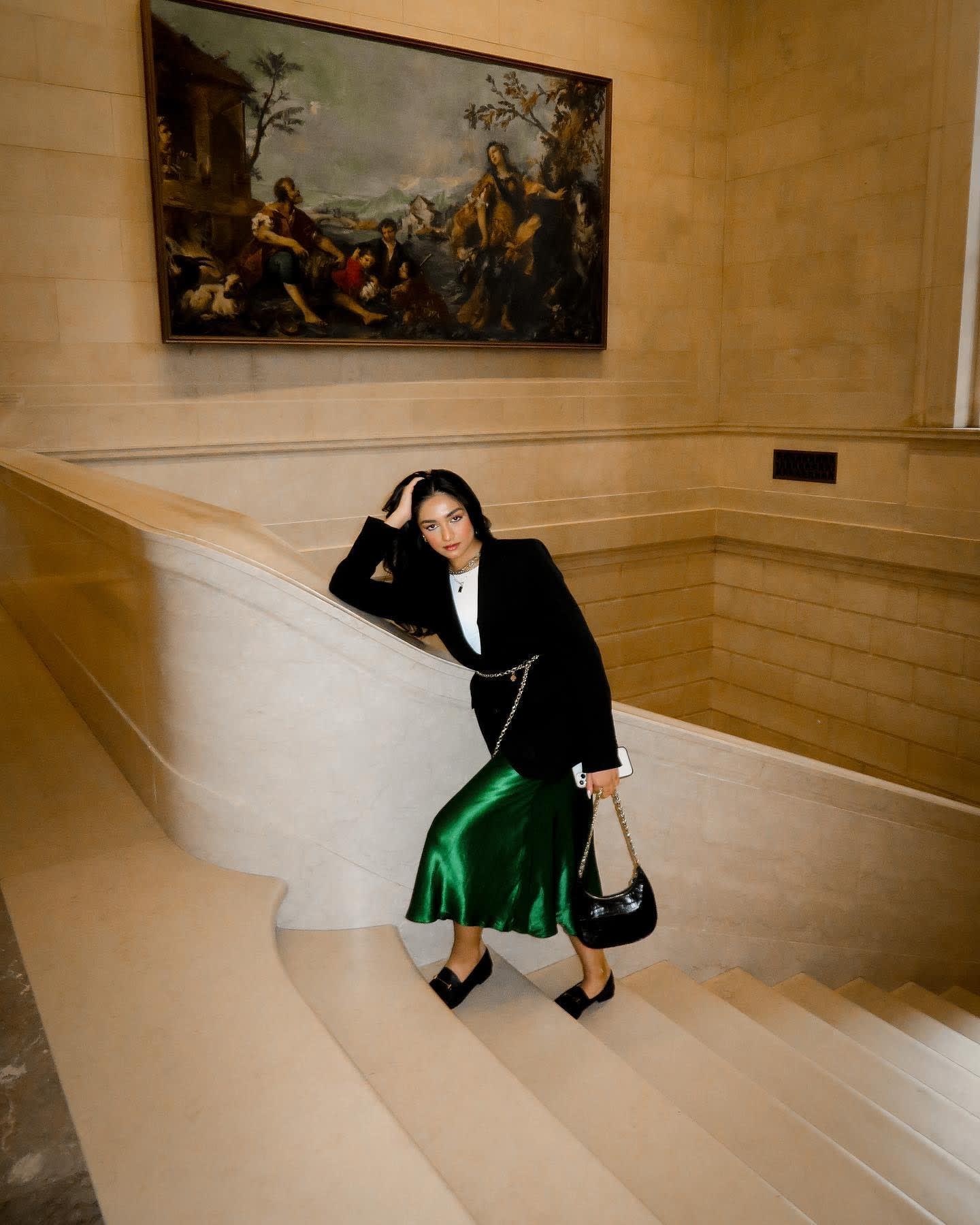 Woman posing for a picture on a set of stairs.