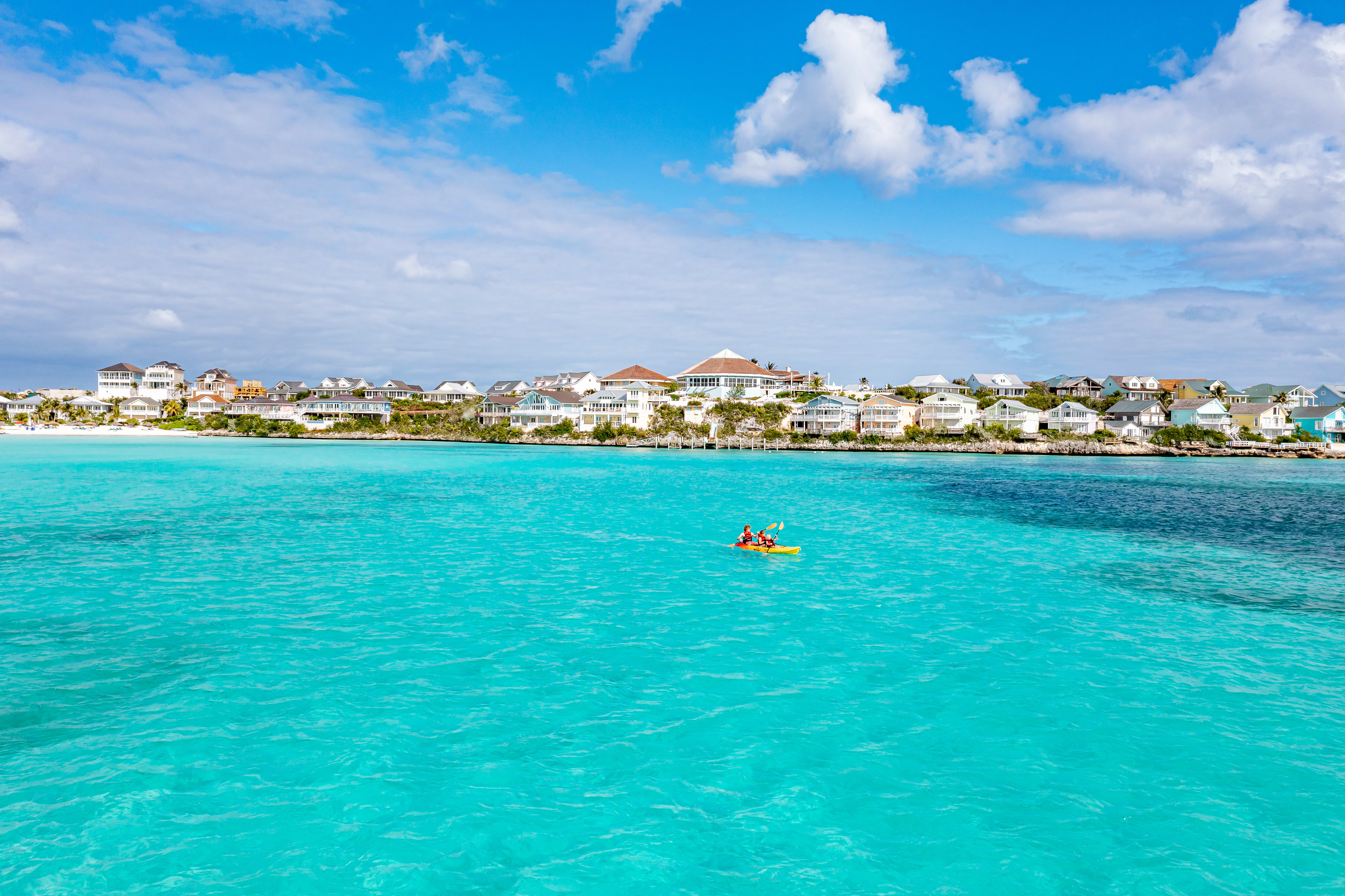 Two people kayaking in clear water in The Bahamas.