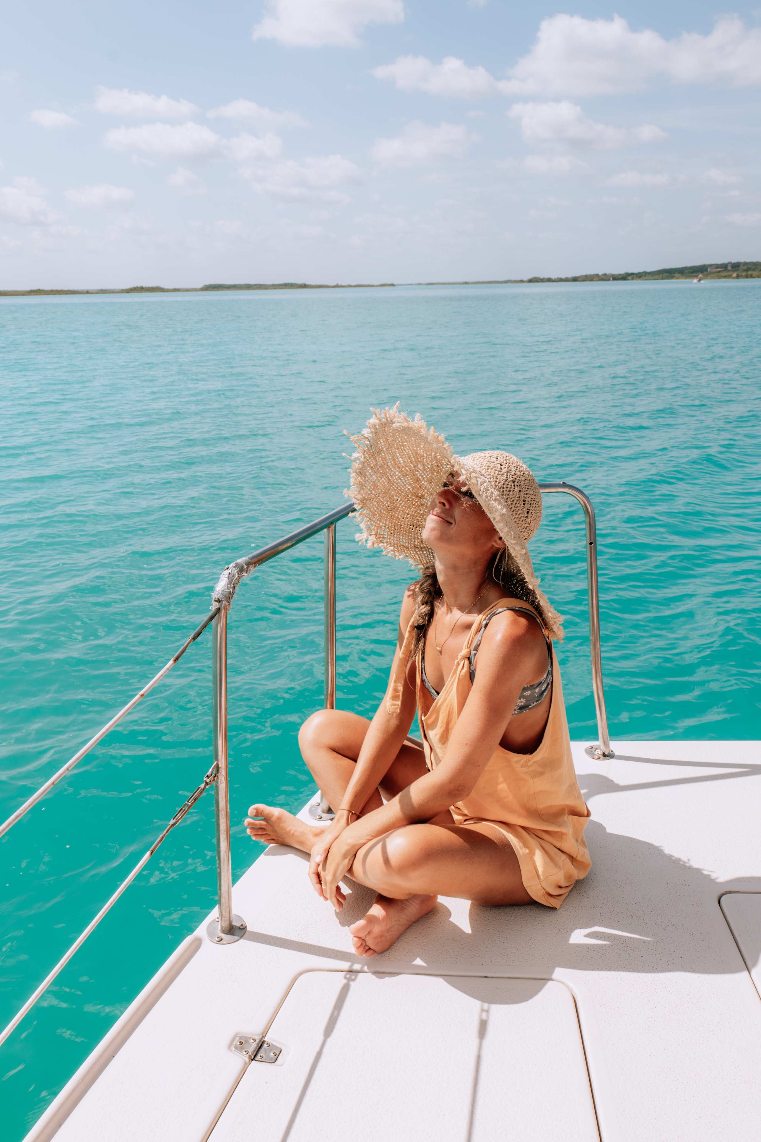 Woman relaxing on a boat under the sun.