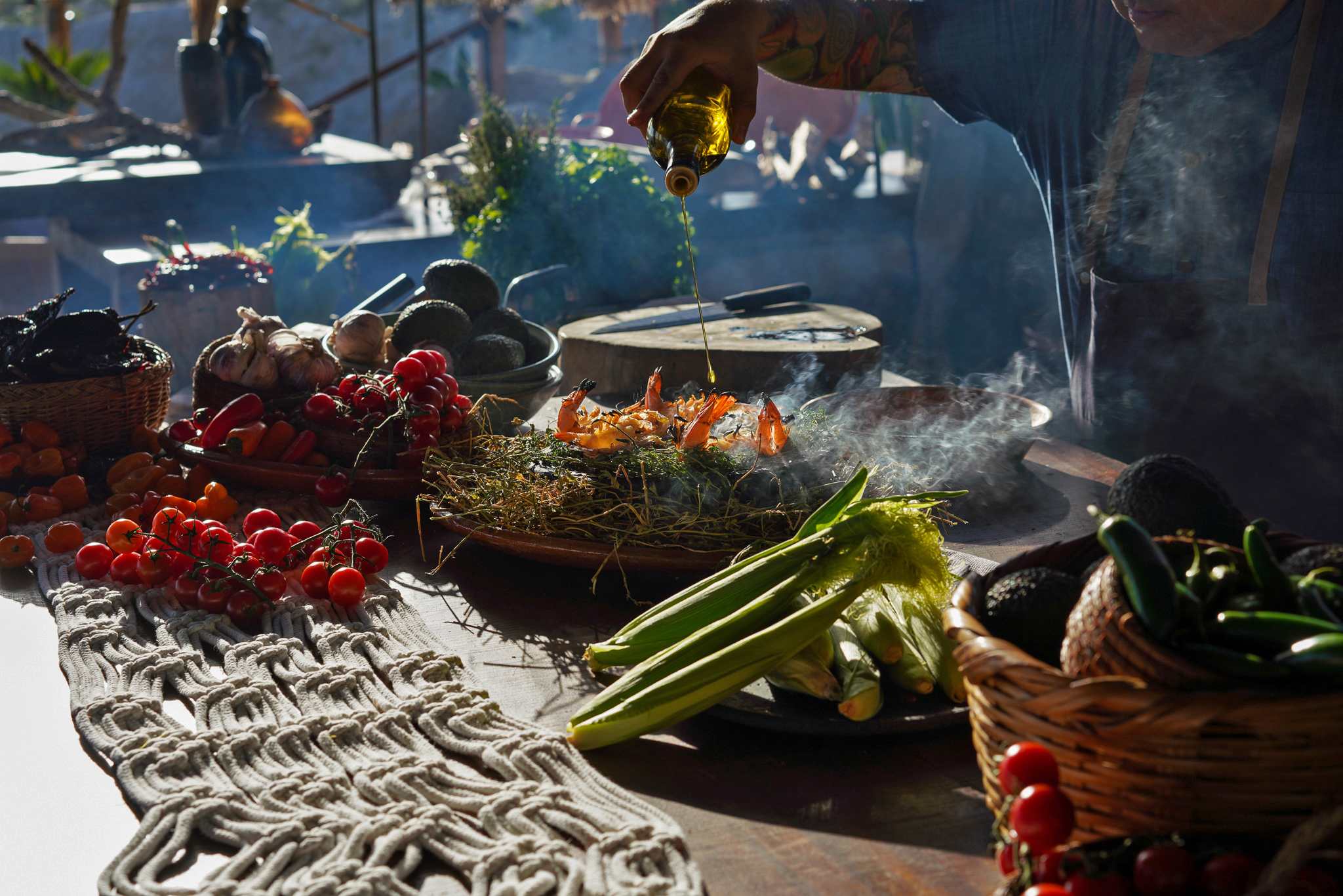 A chef preparing a shrimp dish with vegetables.