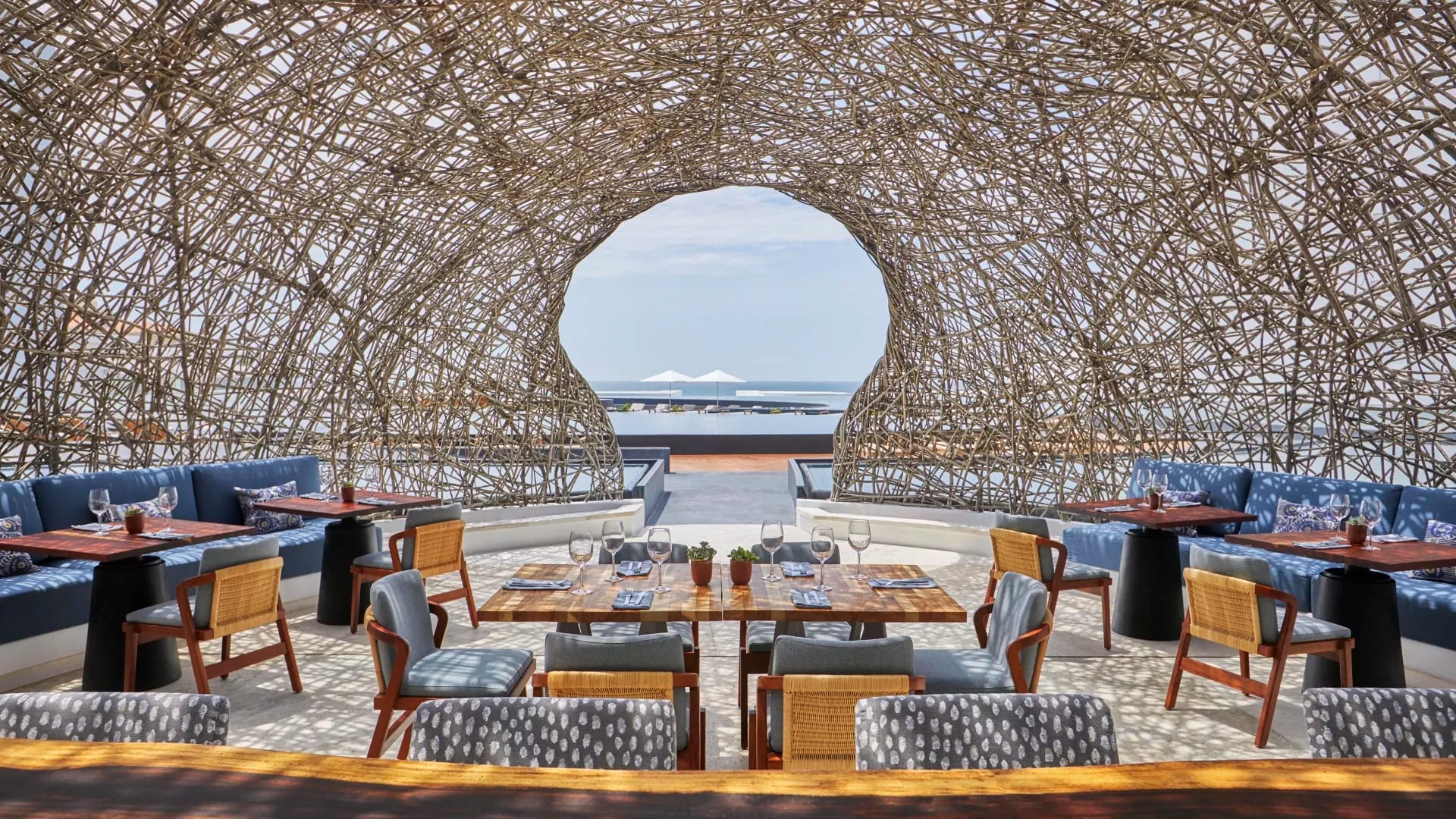 Dining tables under a cabana at a luxury resort in Los Cabos, Mexico.