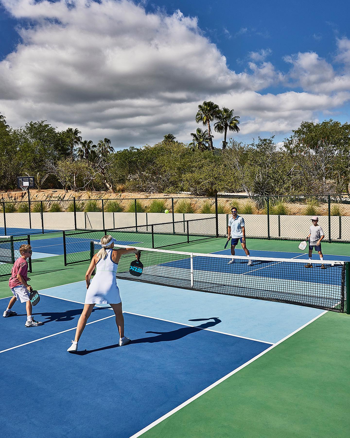 A family playing pickleball at a luxury resort in Los Cabos, Mexico.
