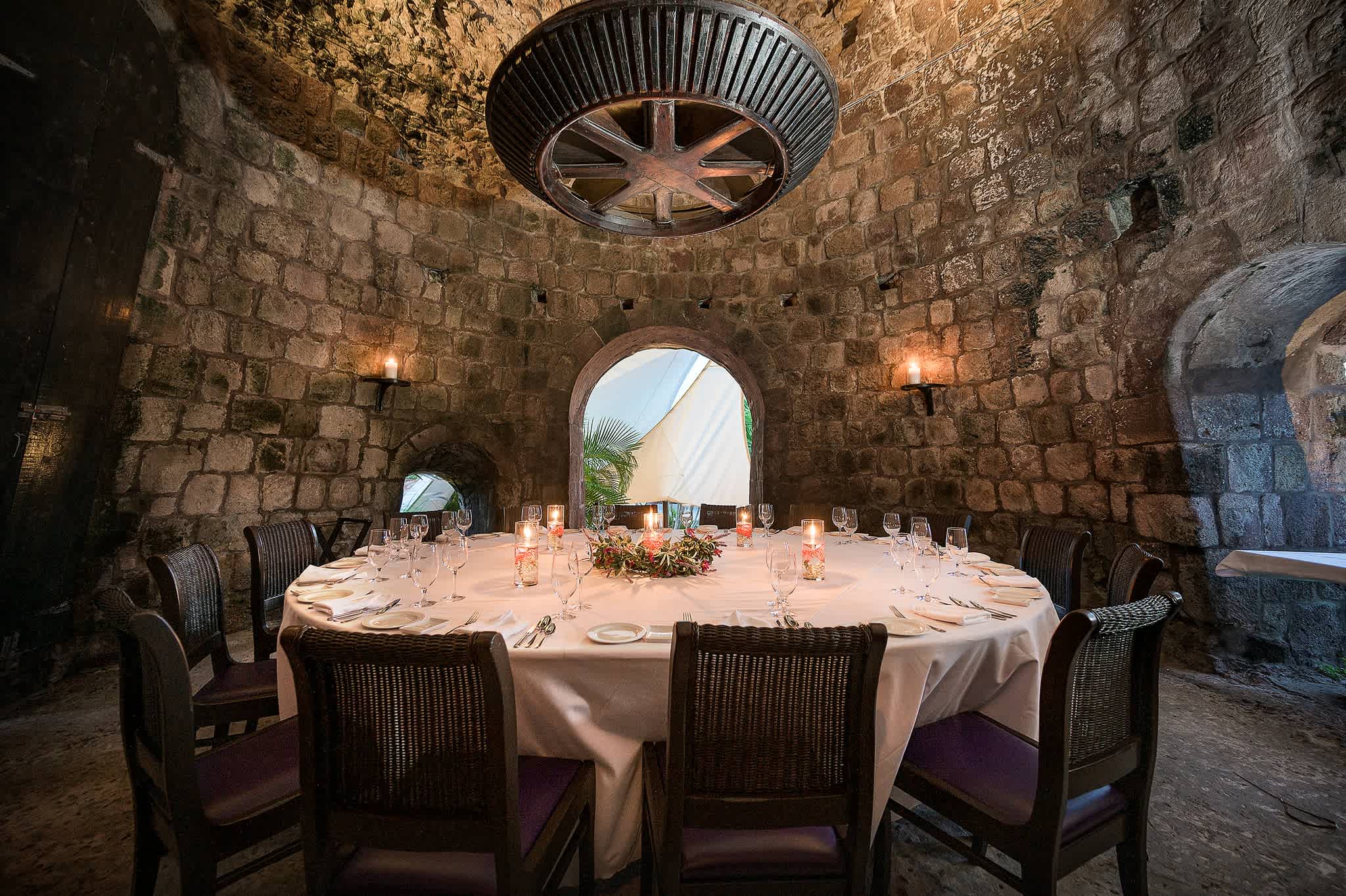 Elegant dining table set inside a rustic stone room at Montpelier Plantation & Beach in Nevis