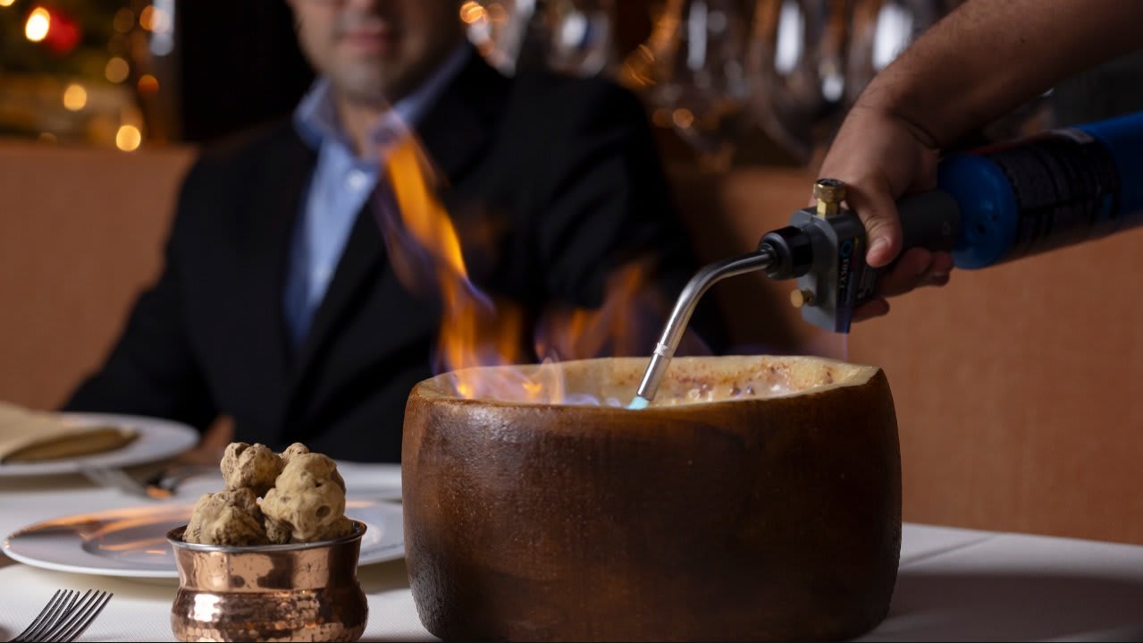 Chef preparing a flaming dish at Bottega restaurant in Napa Valley