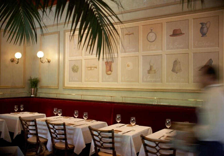 Interior dining area at Bouchon Bakery in Napa Valley with elegant table settings and framed artwork