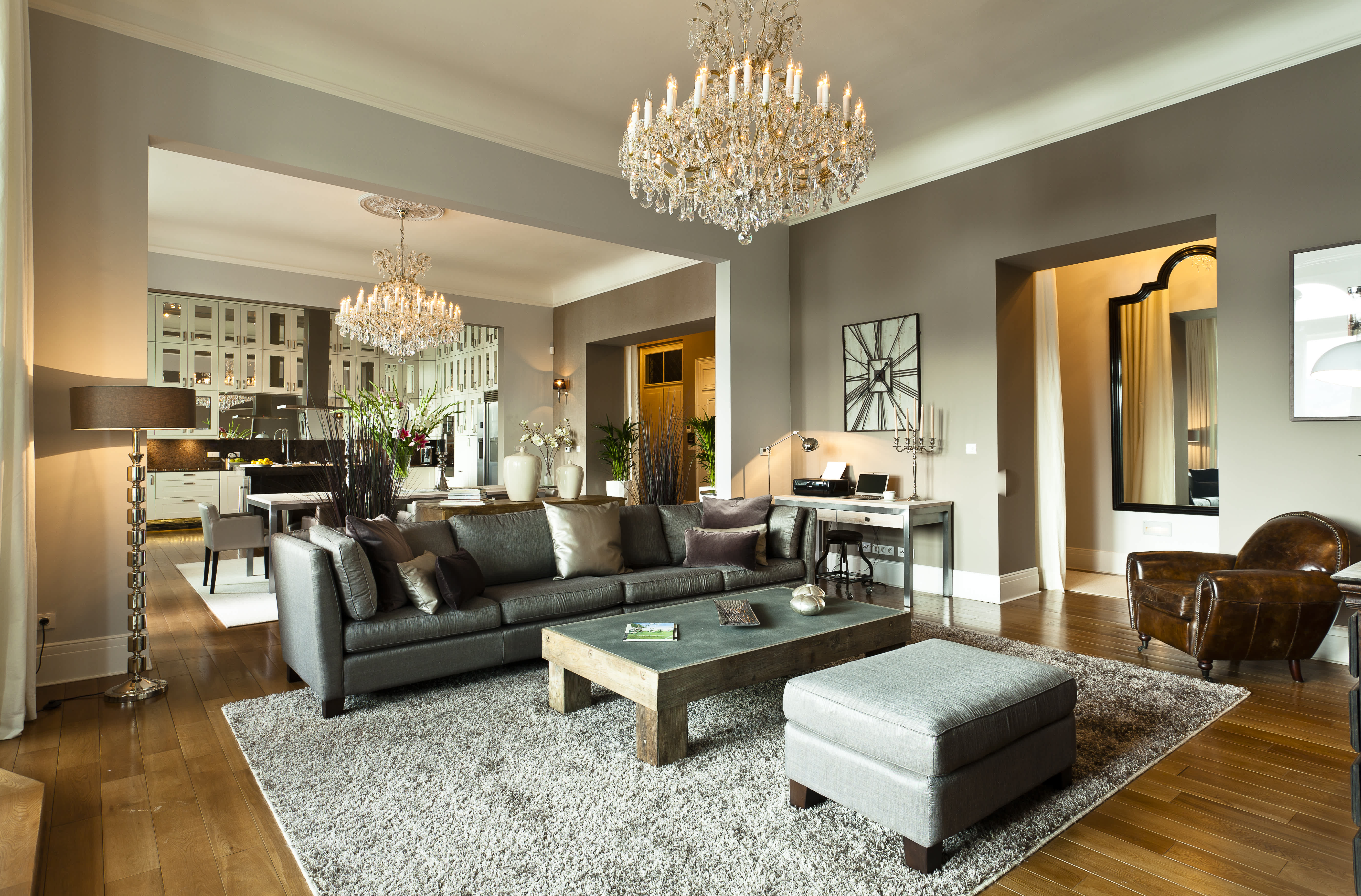 Exclusive Resorts' private villa in Prague featuring a luxurious living room with elegant chandeliers, modern furnishings, and a cozy atmosphere.