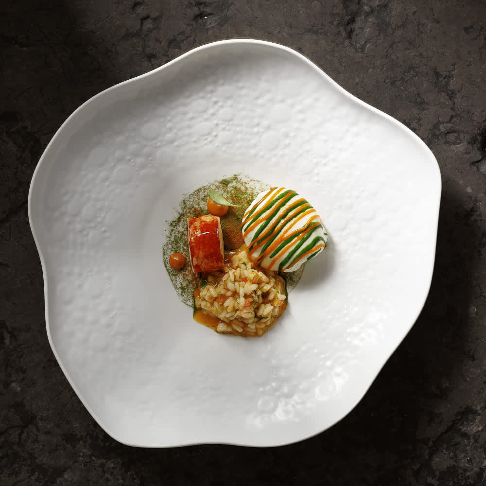 Gourmet dish artfully arranged on a white plate at Alma by Henrique Sá Pessoa in Lisbon, Portugal