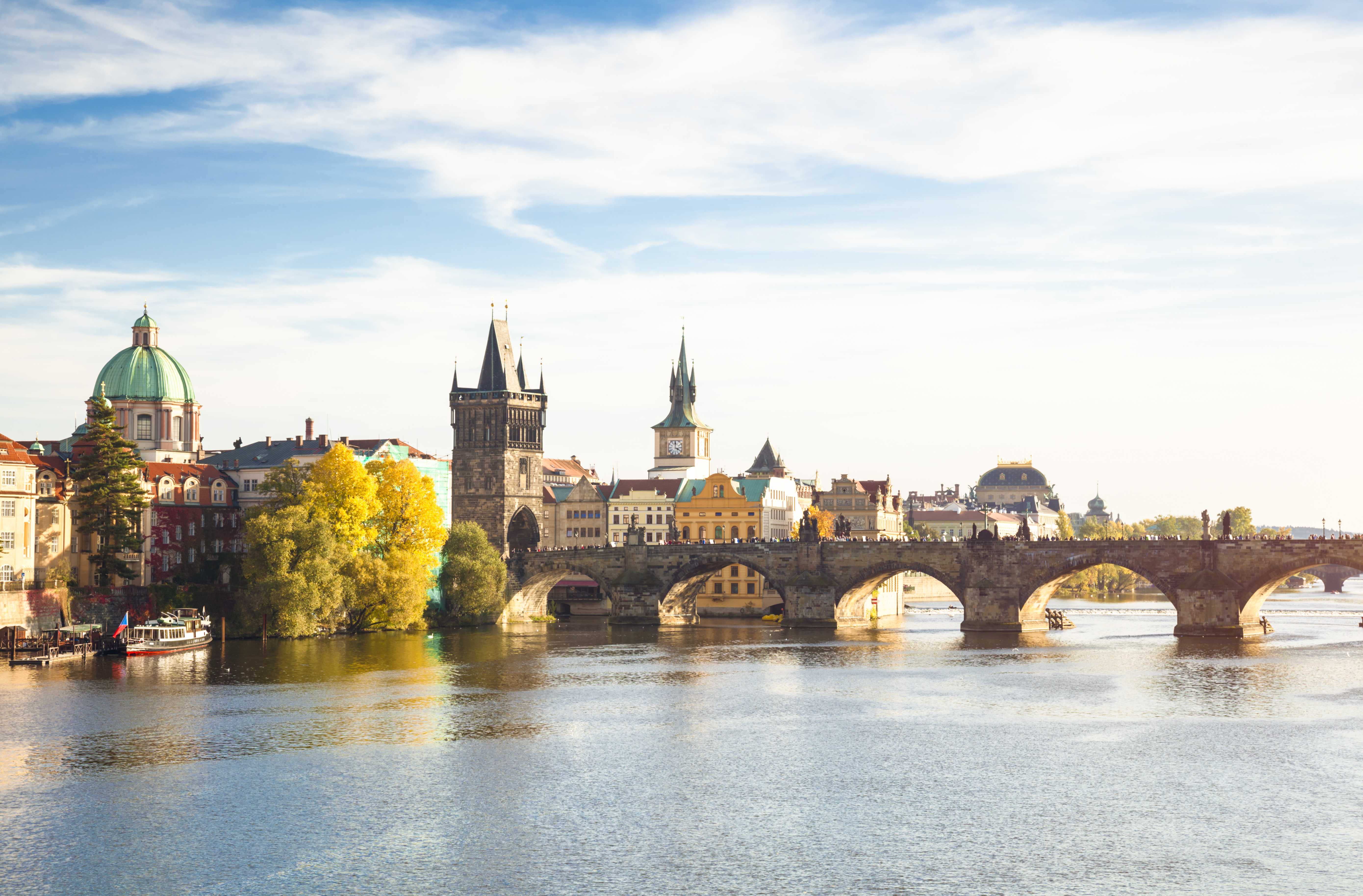 View of Charles Bridge over the Vltava River with towers and historic buildings in Prague, Czech Republic