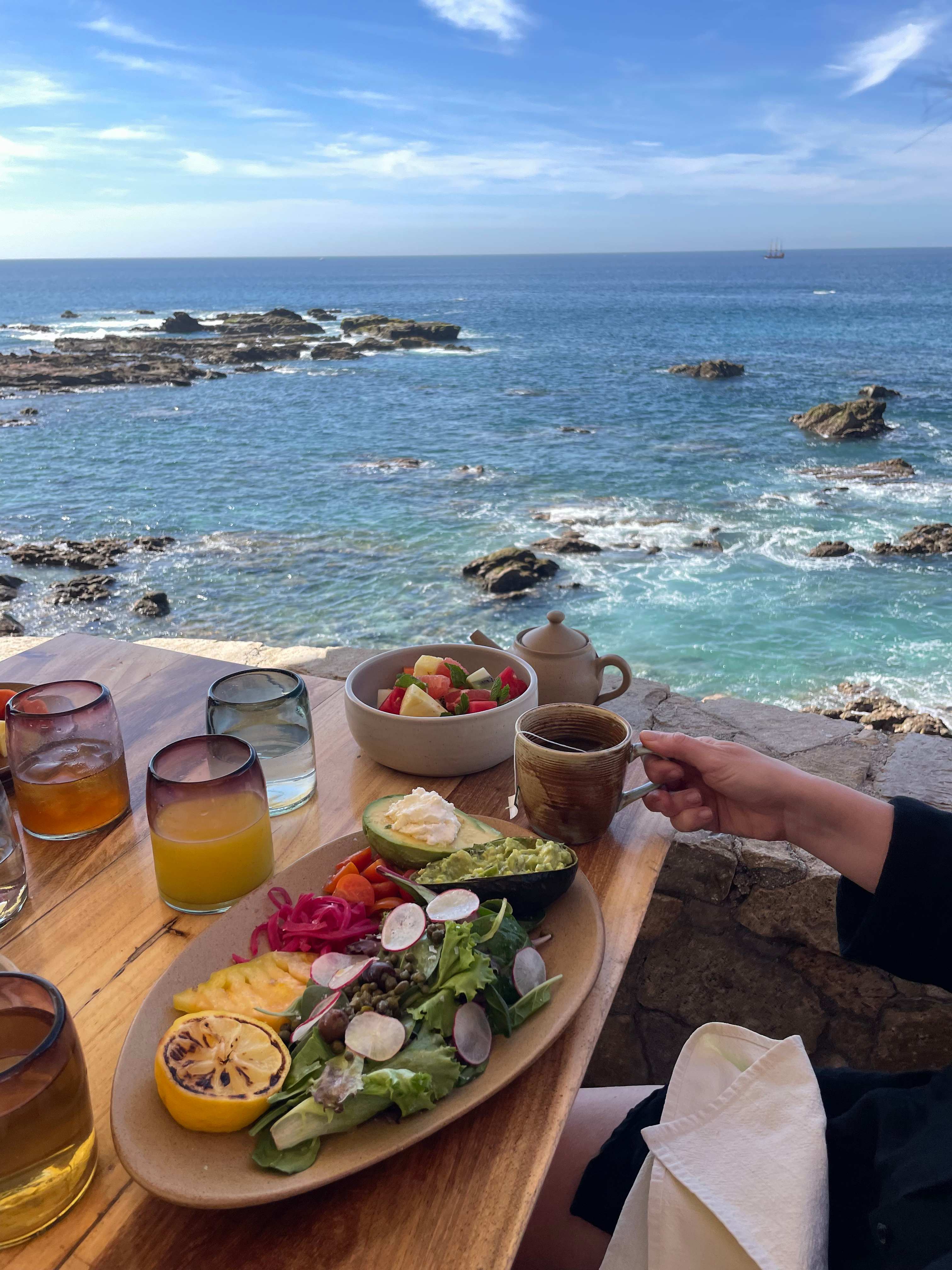 Breakfast table with a variety of fresh foods overlooking the ocean at Esperanza in Los Cabos, Mexico.