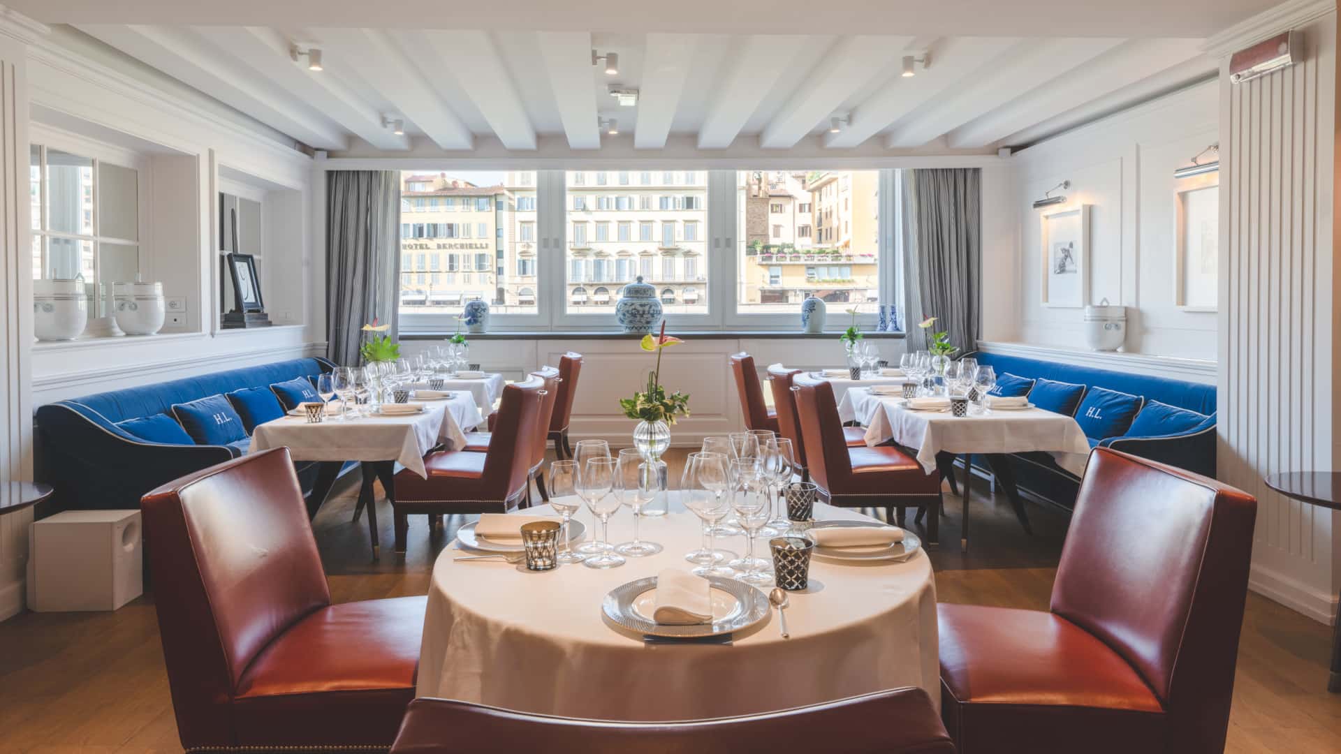 Elegant dining area with modern furniture and large windows in a Borgo San Jacopo restaurant, Florence, Italy