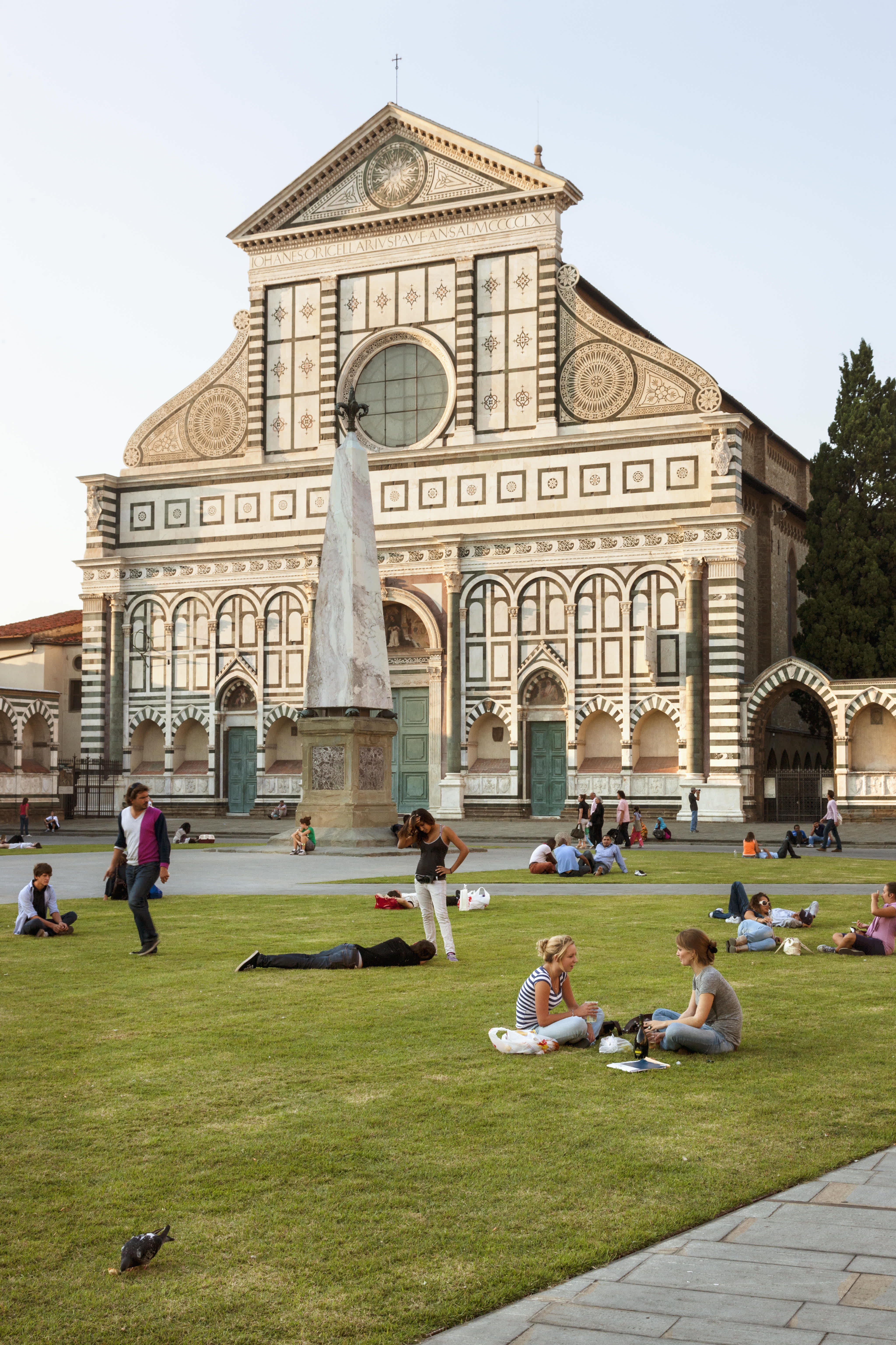 People relaxing on the grass in front of Santa Maria Novella