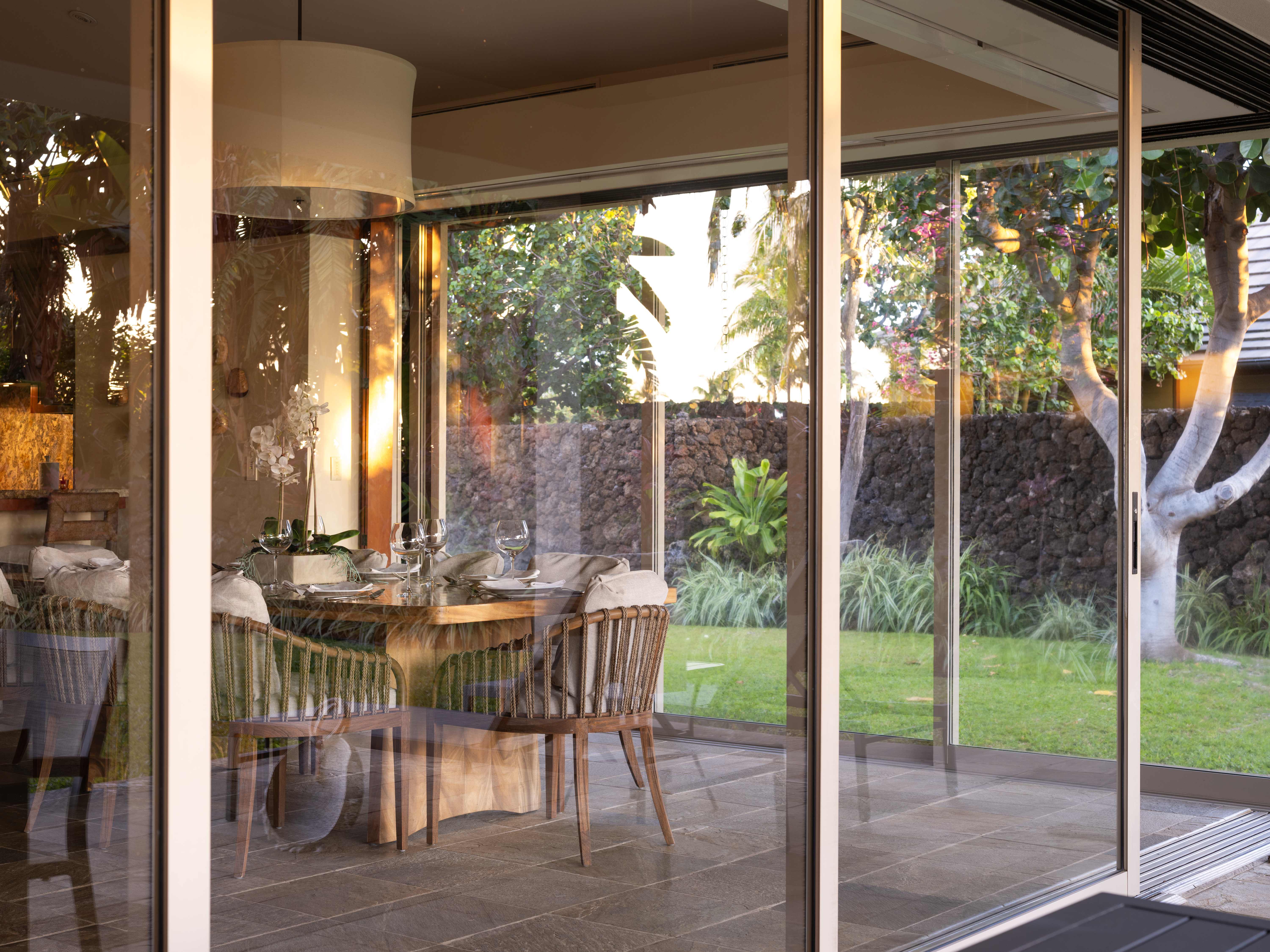 Elegant dining area with garden view at Pauoa Beach Club on the Kohala Coast.