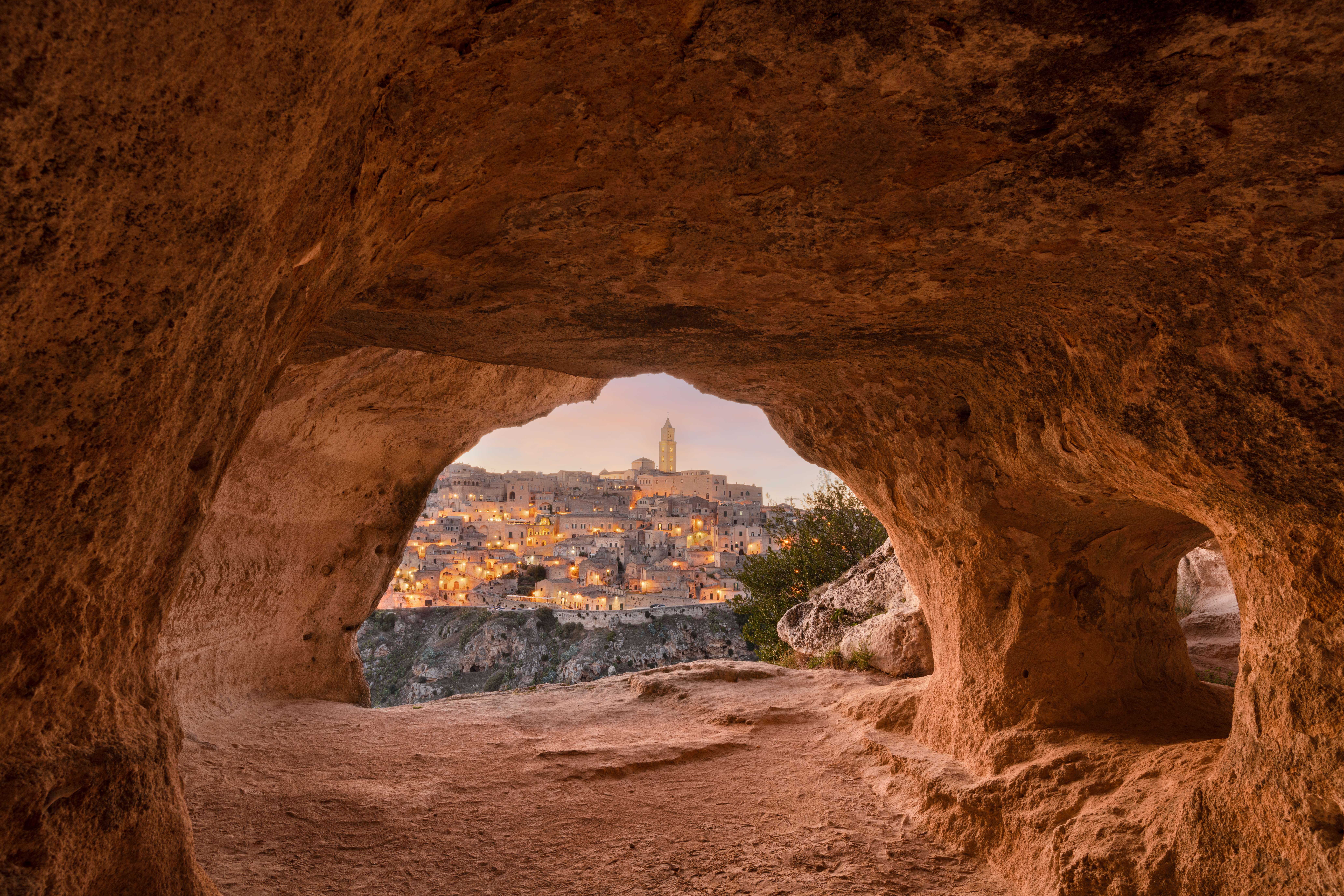 View of Matera's historic town through a cave at sunset on the Amalfi Coast.