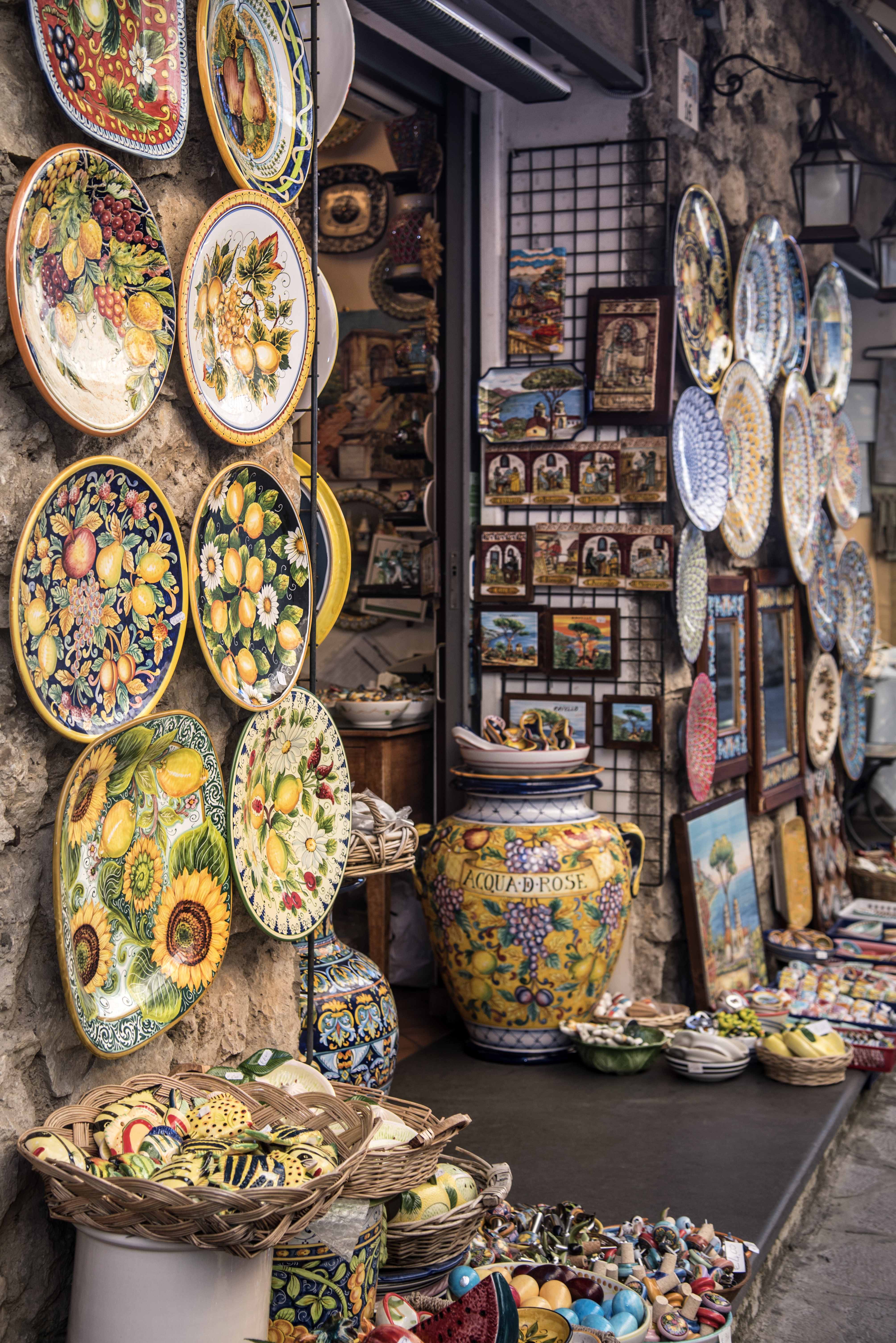 Colorful ceramic plates and pottery displayed outside a shop in Amalfi Coast.