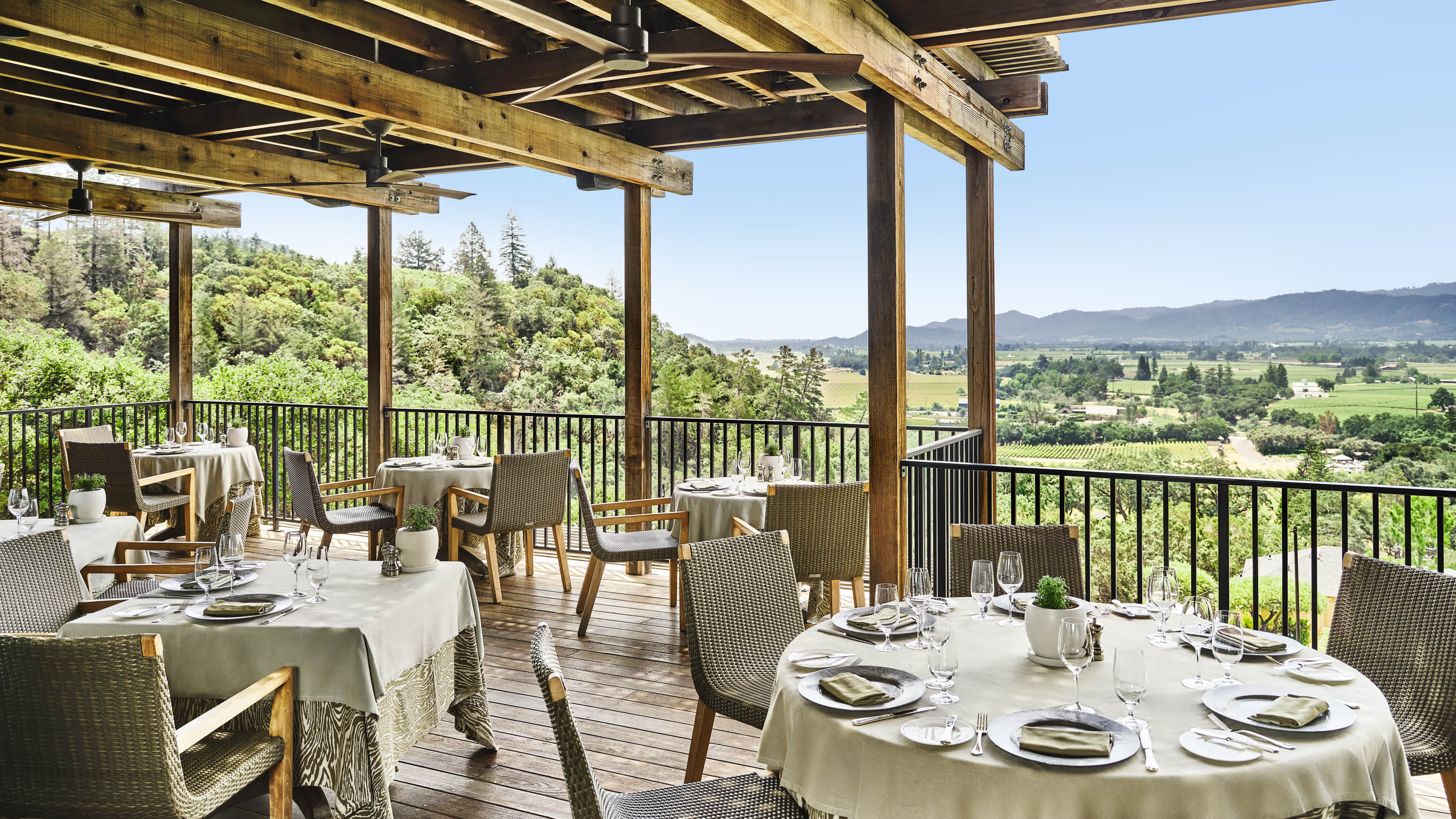 Outdoor dining area at The Restaurant at Auberge du Soleil with a scenic view of Napa Valley vineyards.